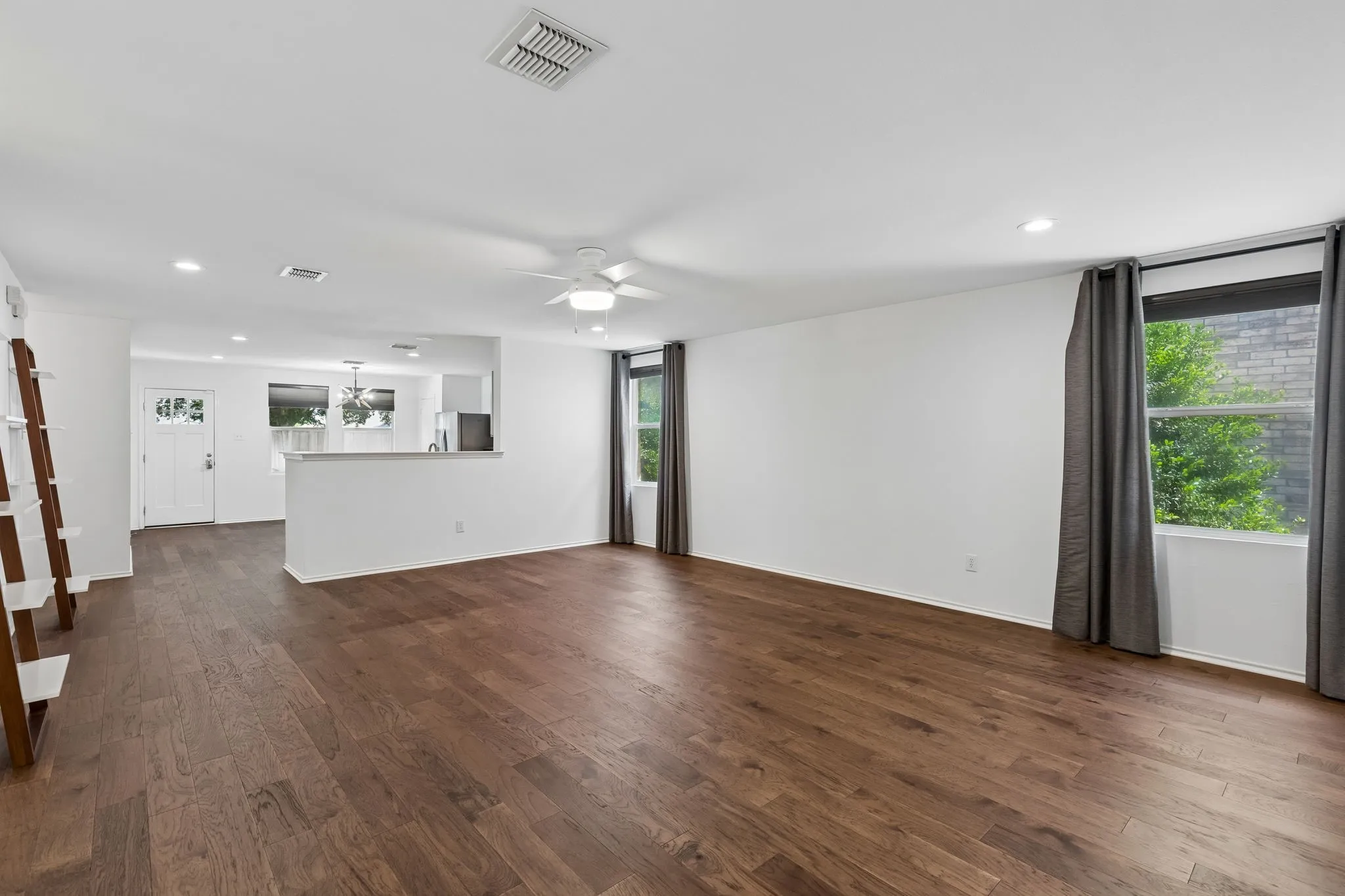 Open floor plan with wood flooring throughout.