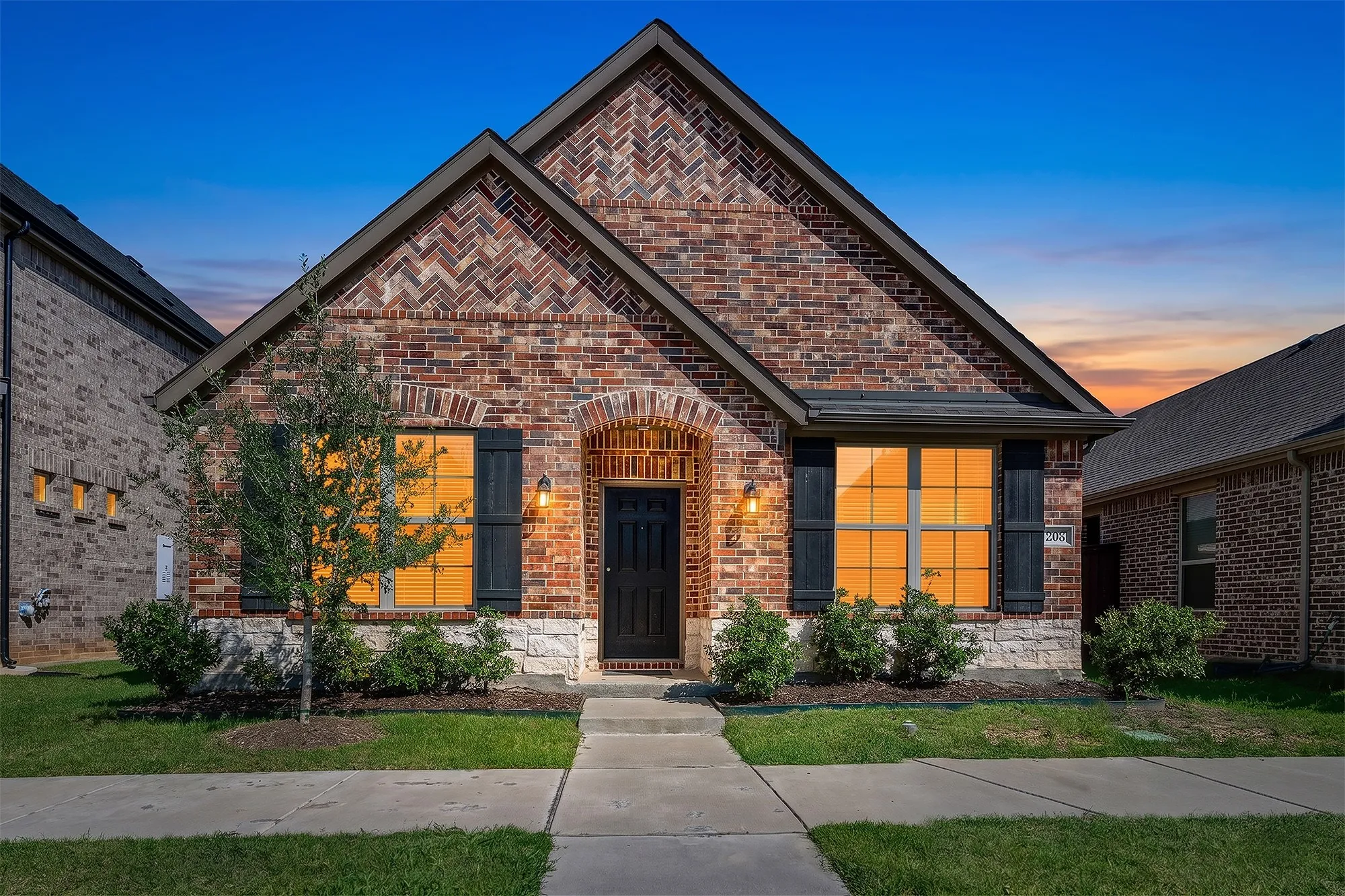 Brick exterior with stone accents and dark shutters