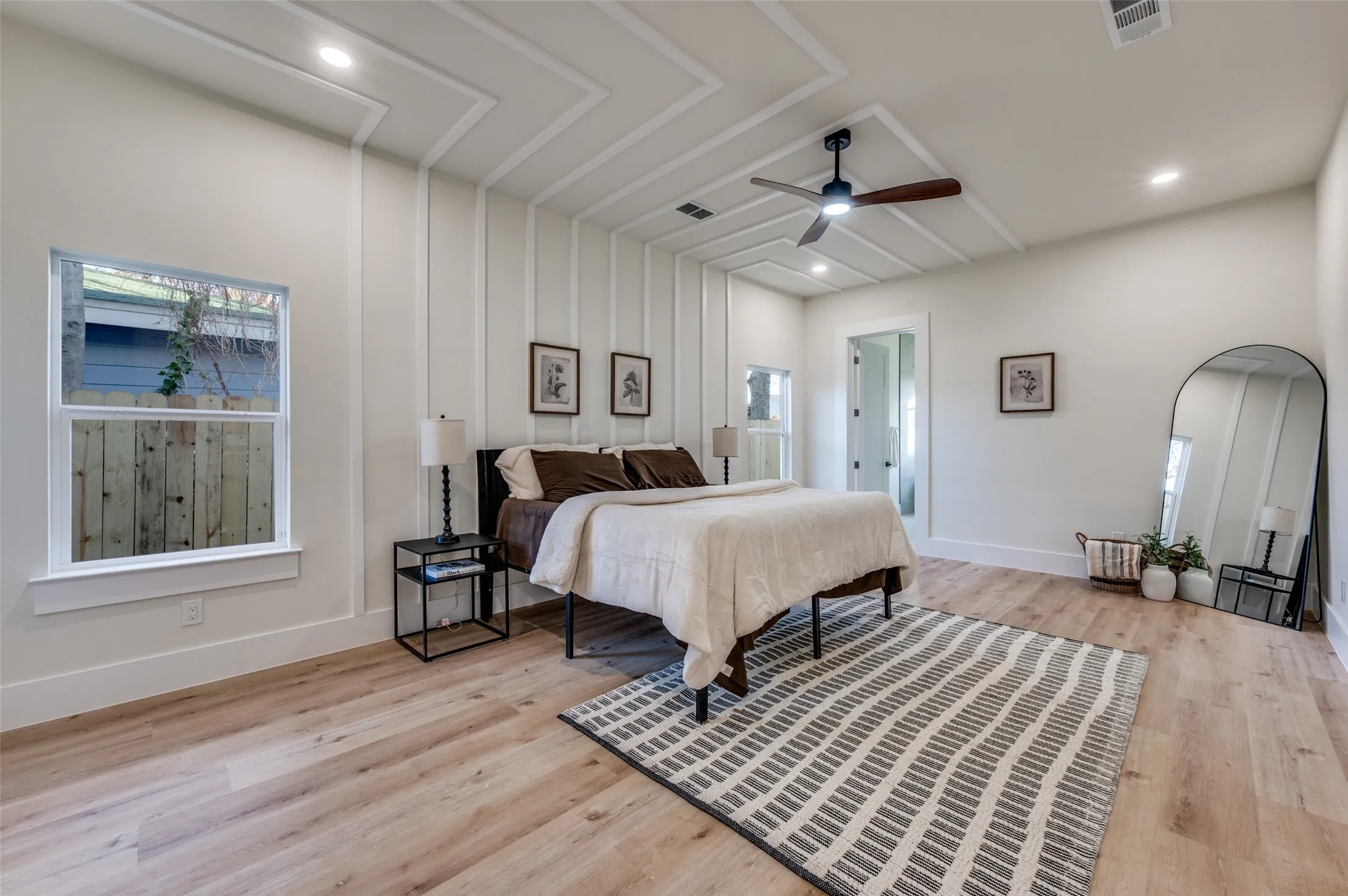 Vaulted ceiling featuring decorative molding and a modern ceiling fan