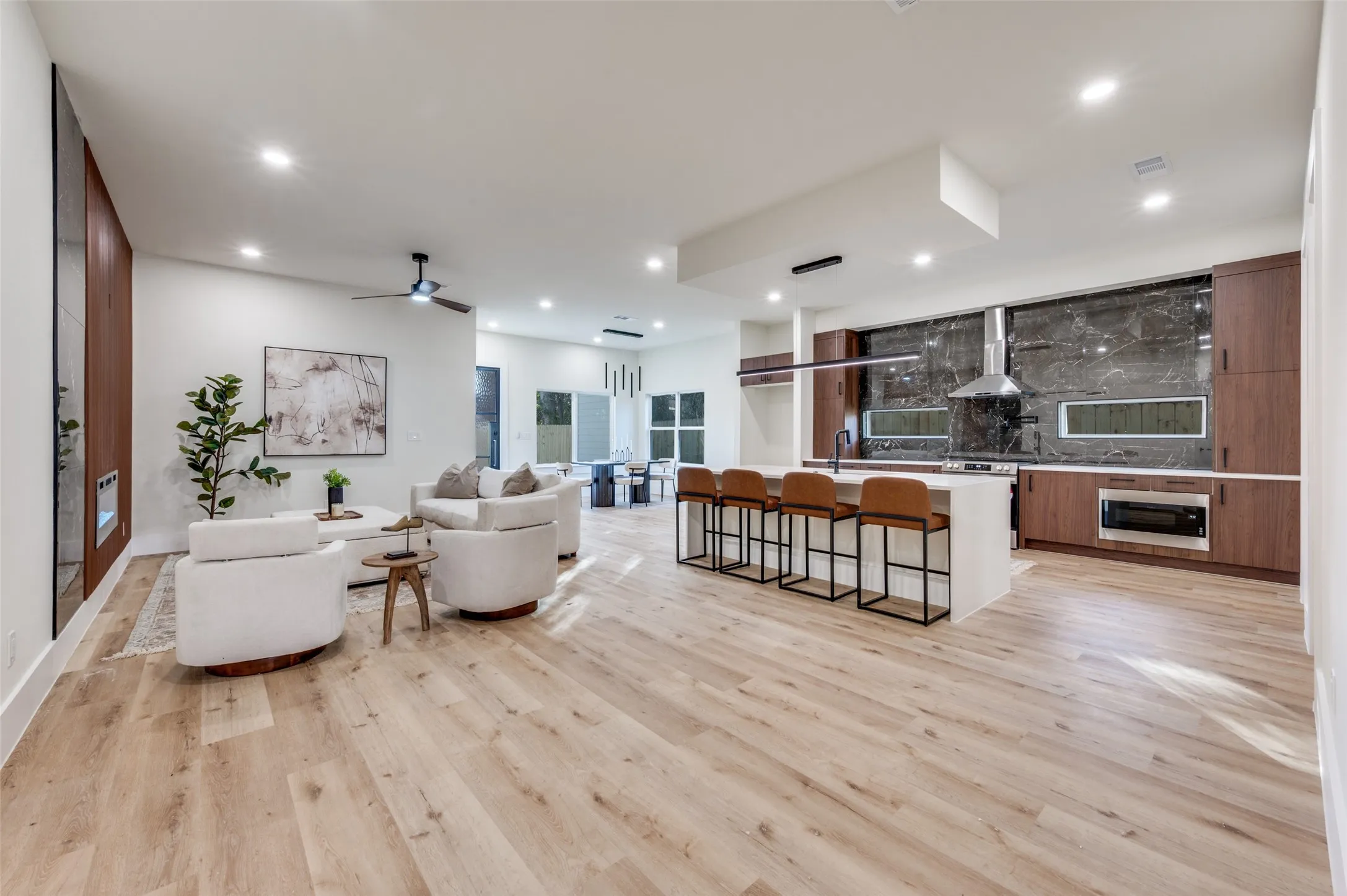 Open-concept living space with light wood-finish flooring throughout