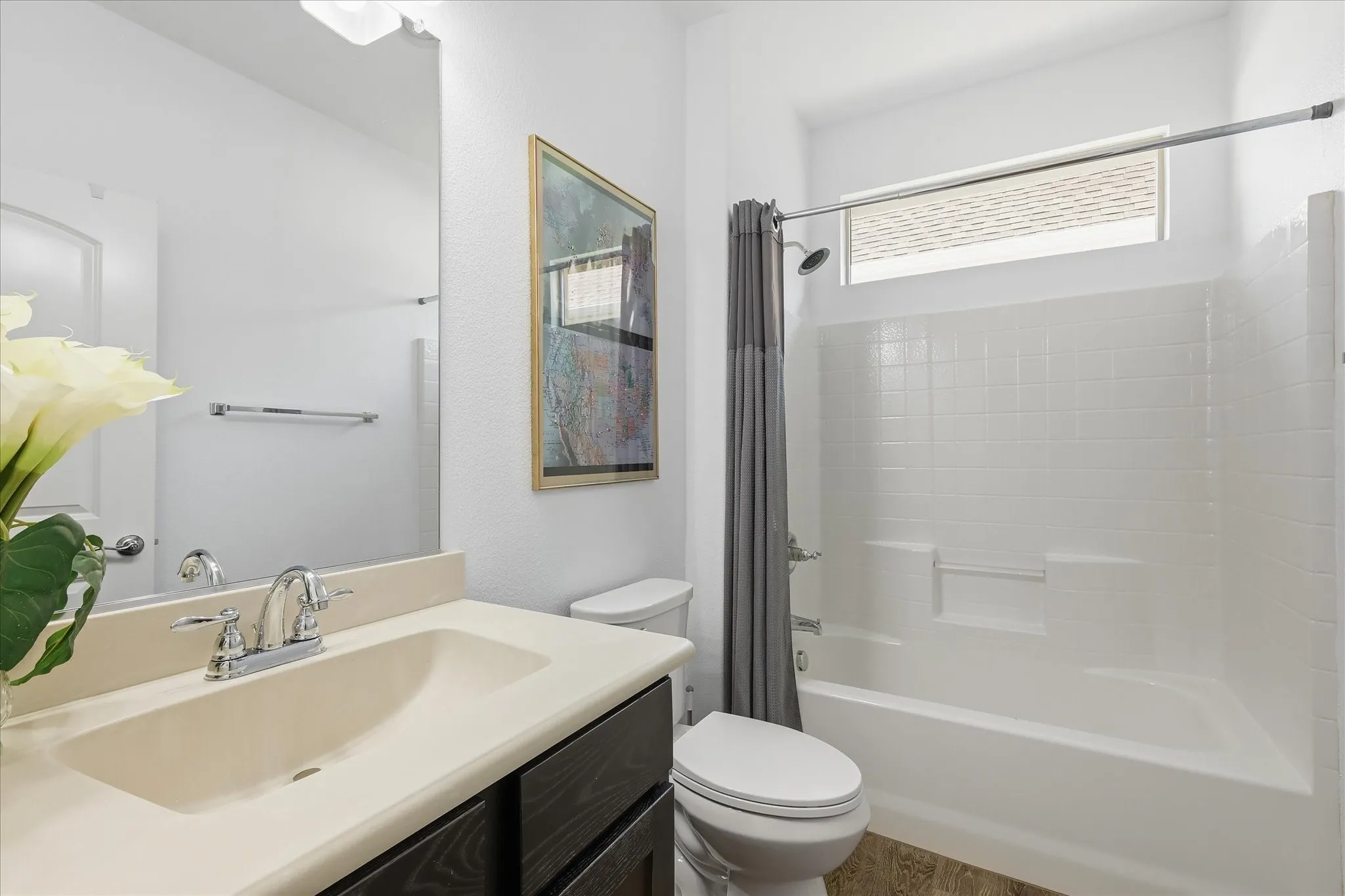 Bathroom featuring a built-in vanity with an integrated sink, chrome faucet, and dark wood-finish cabinetry