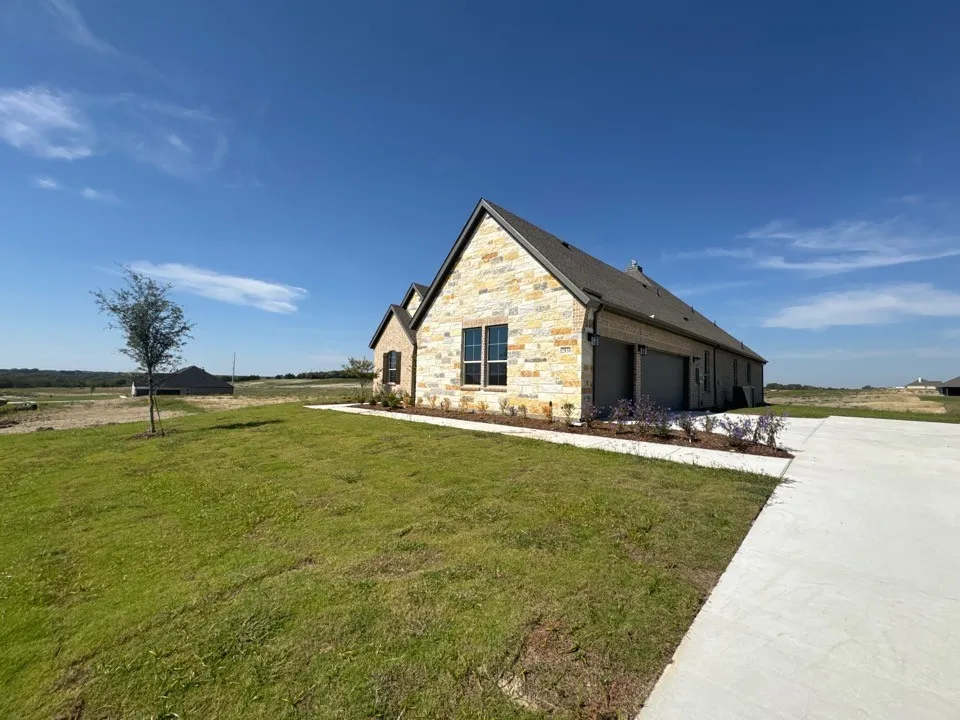 Stone and brick exterior with dark trim windows