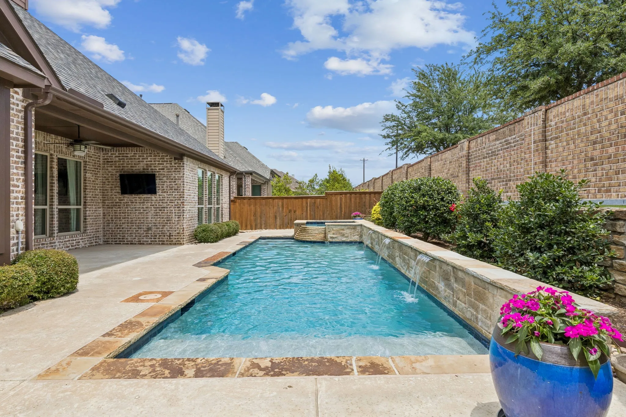 Water-spill fountains enhance the stone wall.