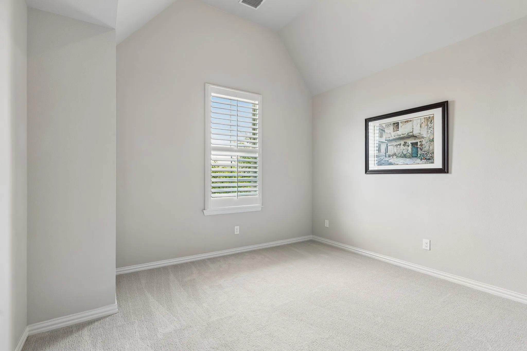 Front secondary bedroom with high ceiling, fan & plantation shutters. Perfect for office or guest room.