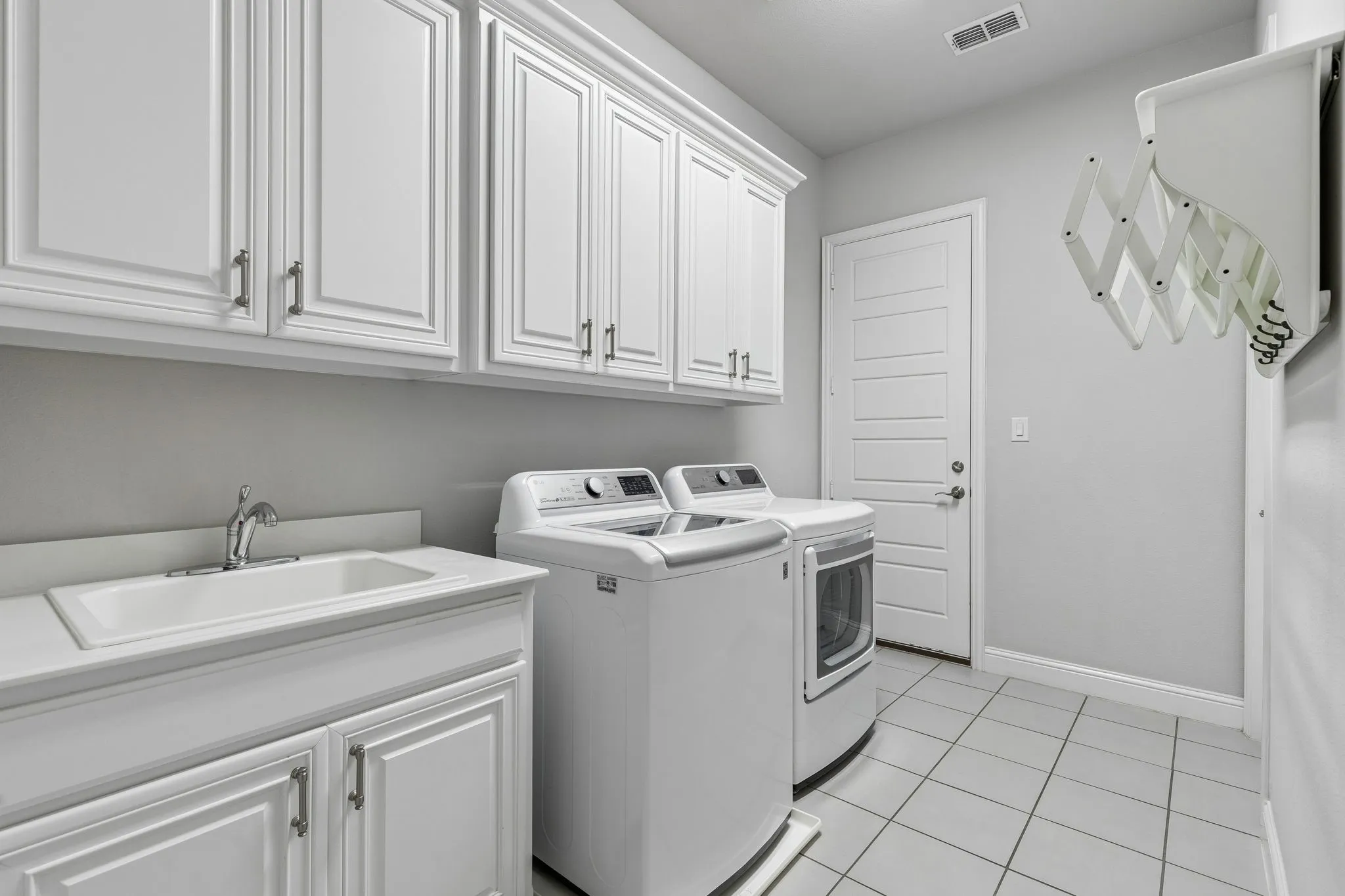 Check out the huge laundry room. Plenty of cupboards & cabinets and that oh so useful sink!
