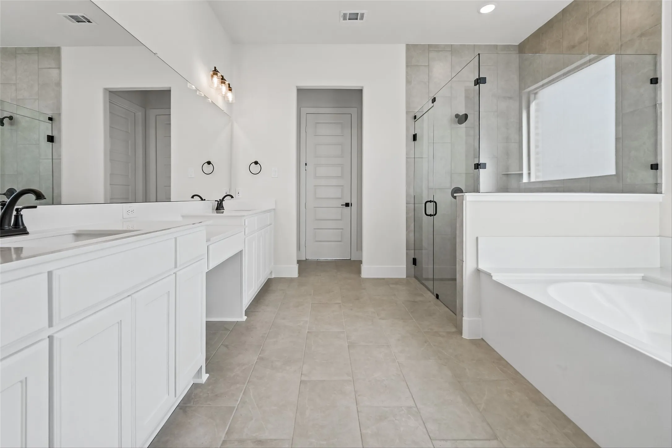 Dual vanity with white cabinetry and integrated sinks