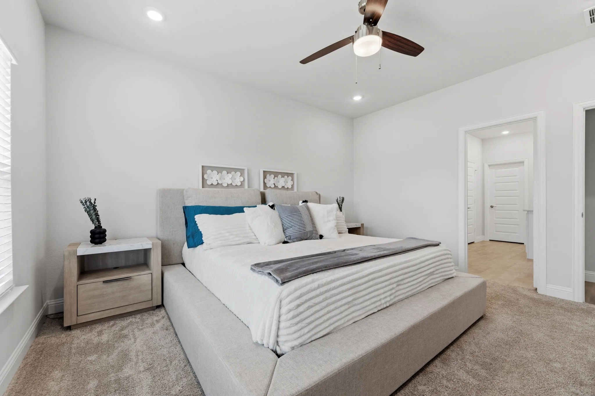 Carpeted bedroom featuring white walls, recessed lighting, and a ceiling fan with integrated light