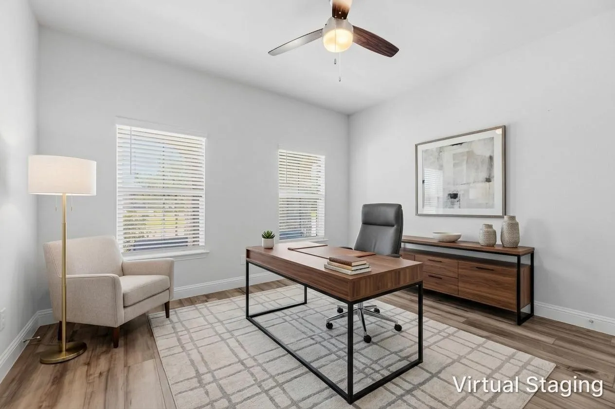 Dedicated room featuring wood-finish flooring, light-toned walls, and a ceiling fan