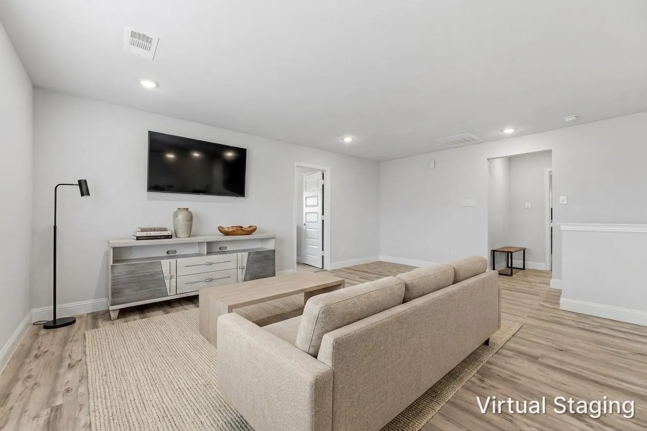 Spacious room featuring light wood-finish flooring, recessed lighting, and crisp white walls