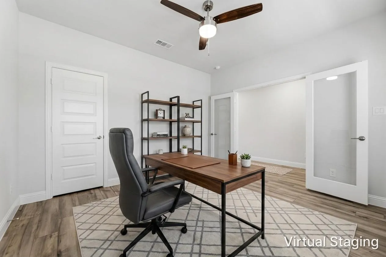 Dedicated room featuring wood-finish flooring, a contemporary ceiling fan with integrated lighting, and white trim
