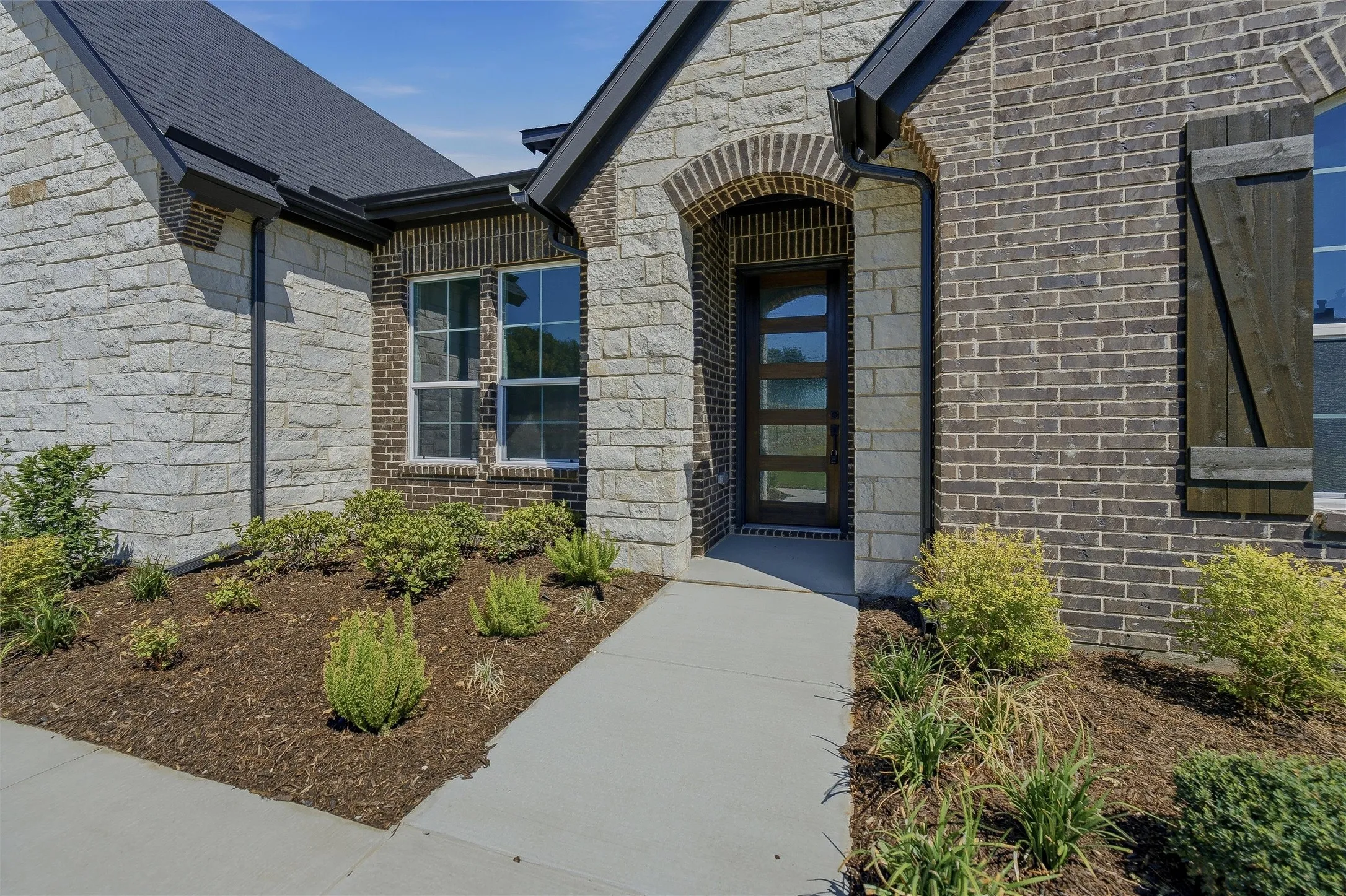Brick and stone facade with an arched entryway