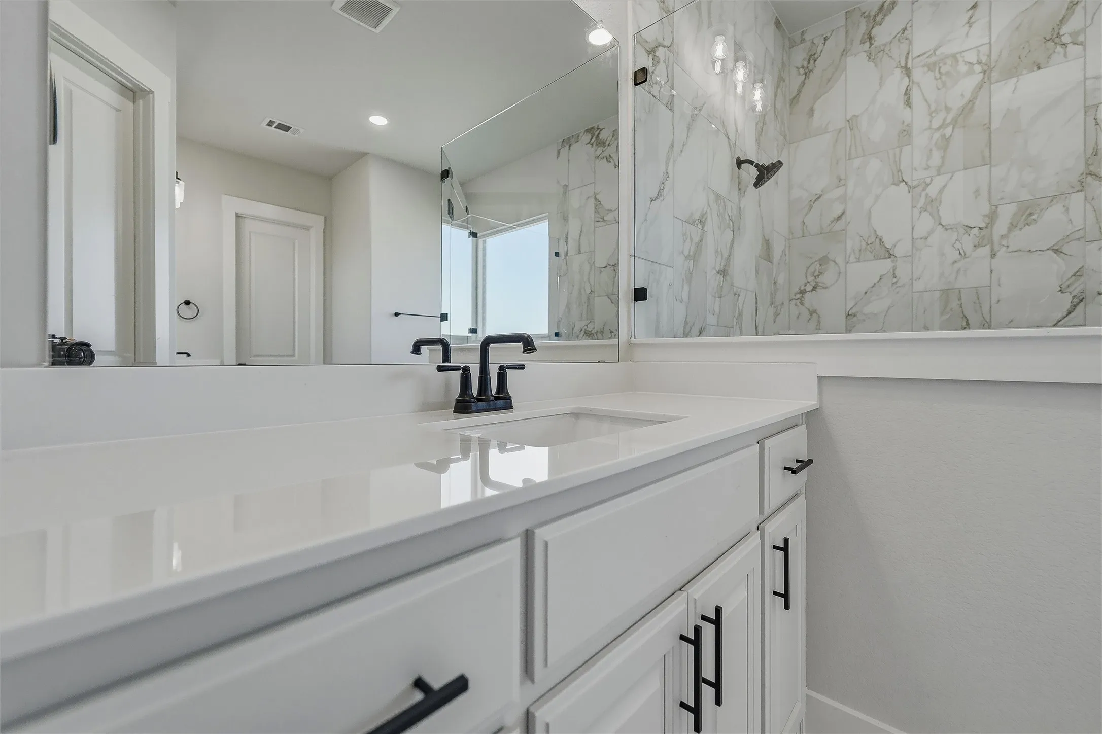 White cabinetry with matte black hardware