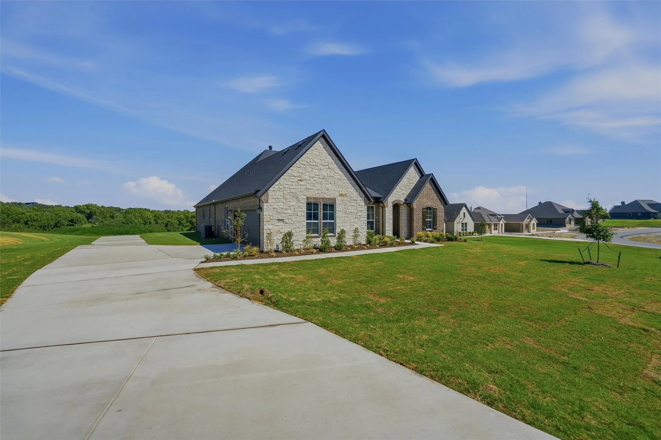 Stone and brick exterior with a black roof