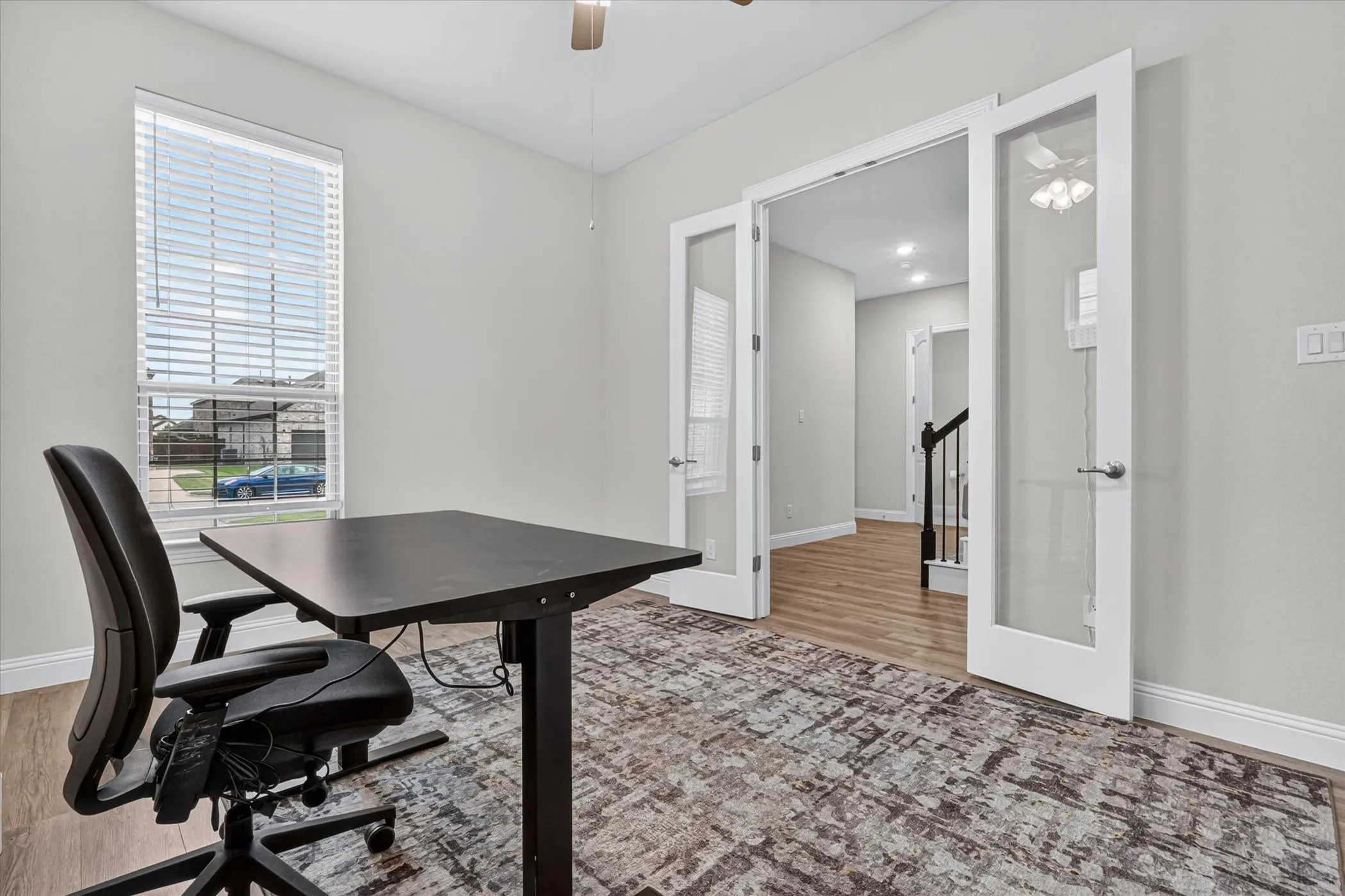 Bright interior room with a single window and white blinds