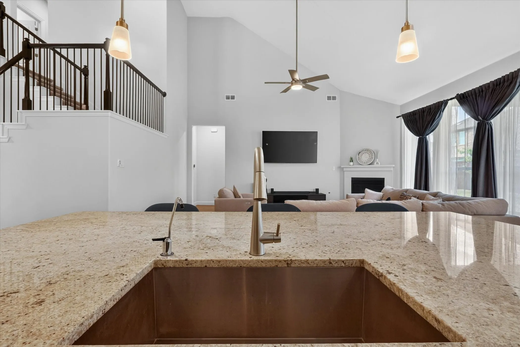 Expansive kitchen island featuring a deep undermount sink and a gooseneck faucet