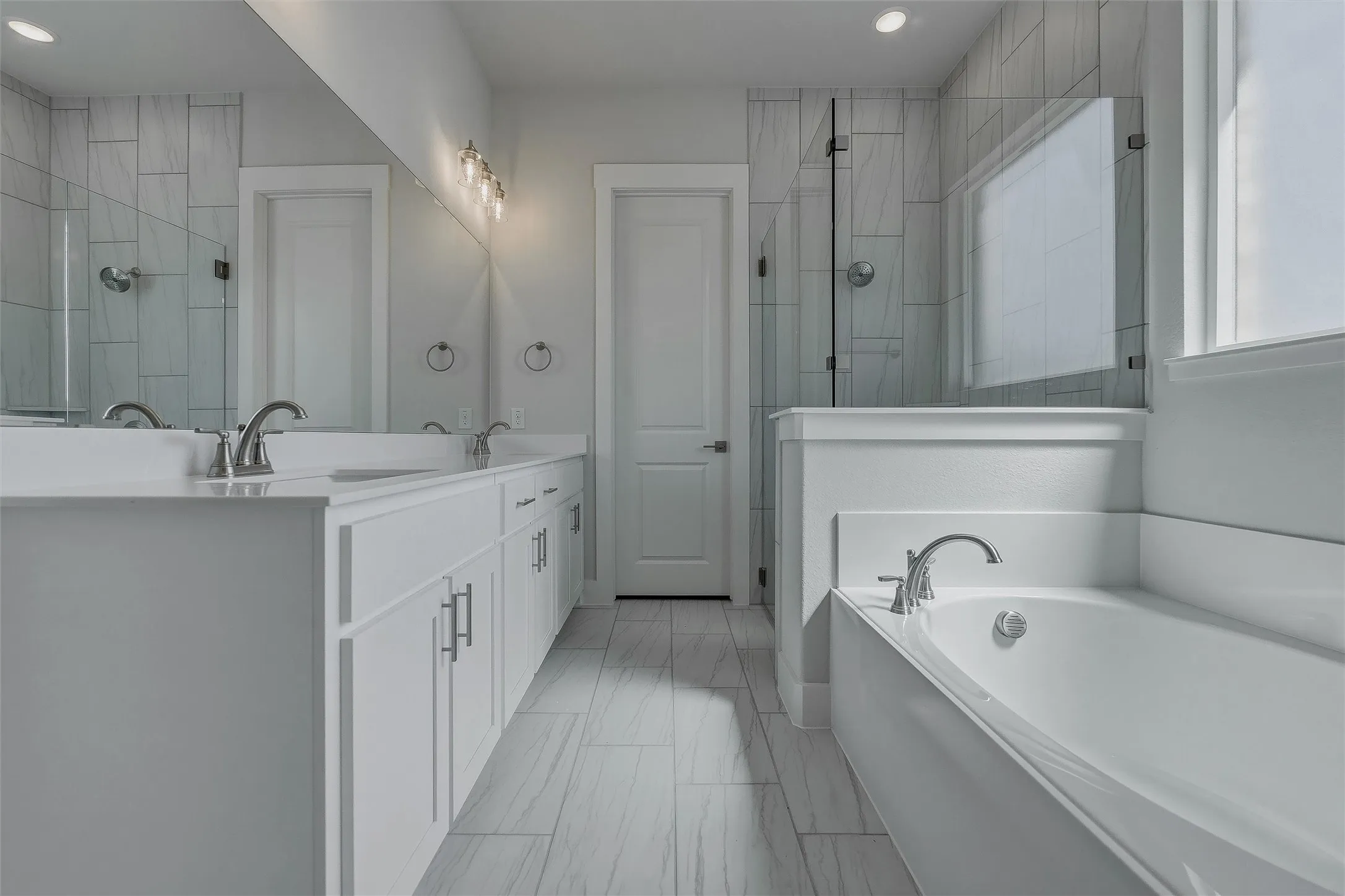 Dual sink vanity with white cabinetry and chrome hardware