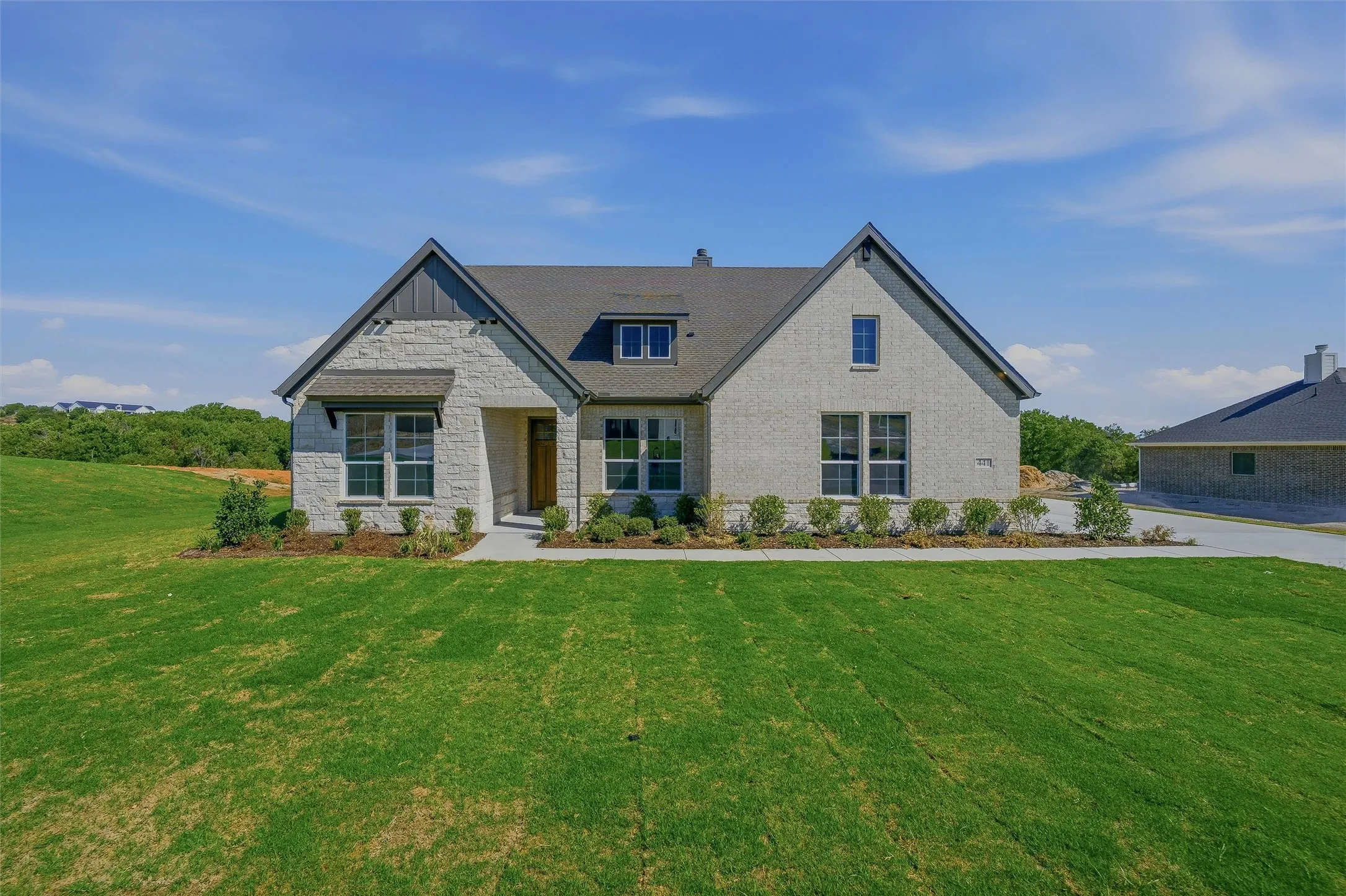 Stone and brick veneer exterior with a dark-toned roof