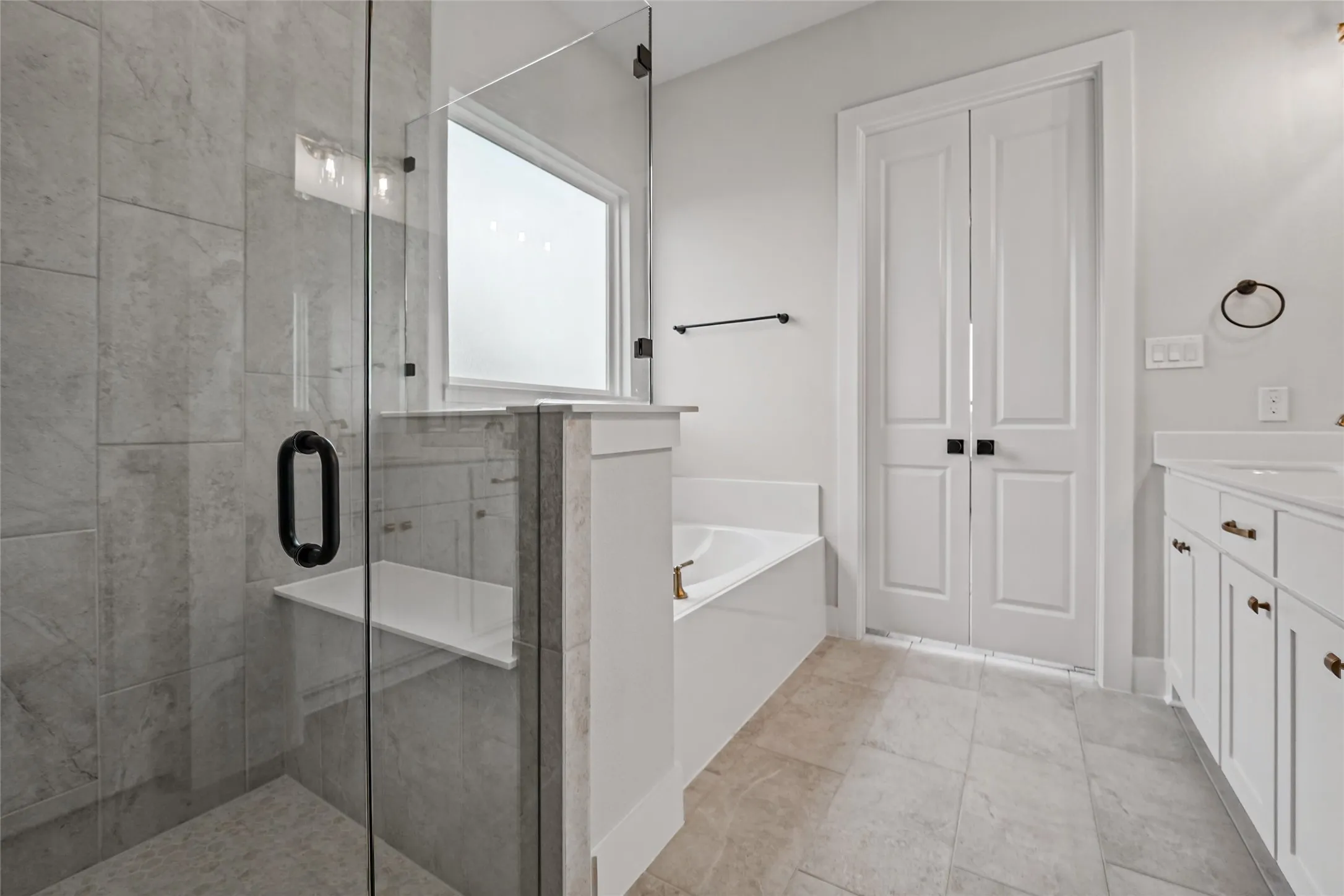 Walk-in shower with tile surround and built-in bench