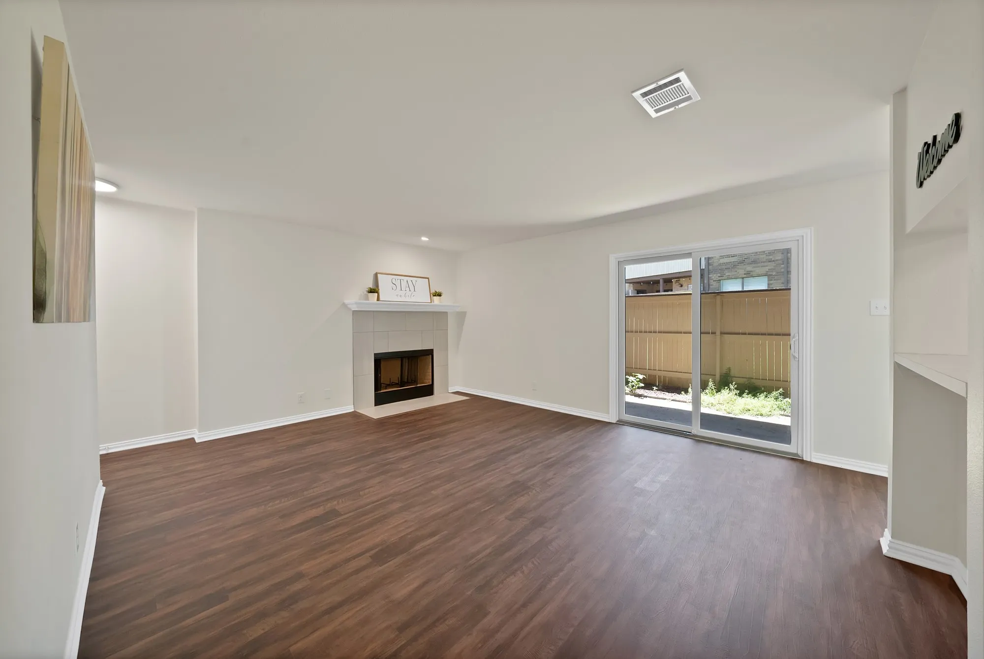 another view of the living room and sliding door to patio