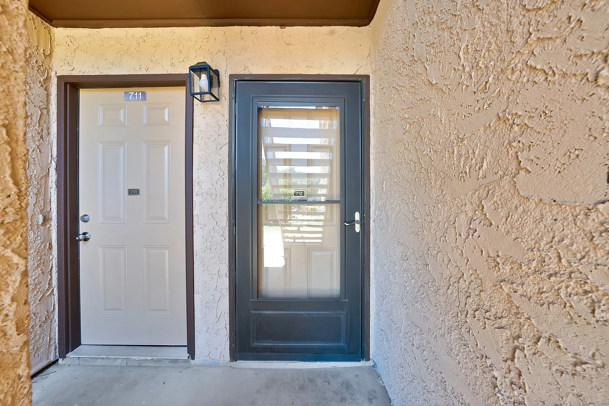 front door is on the right, with screen door.