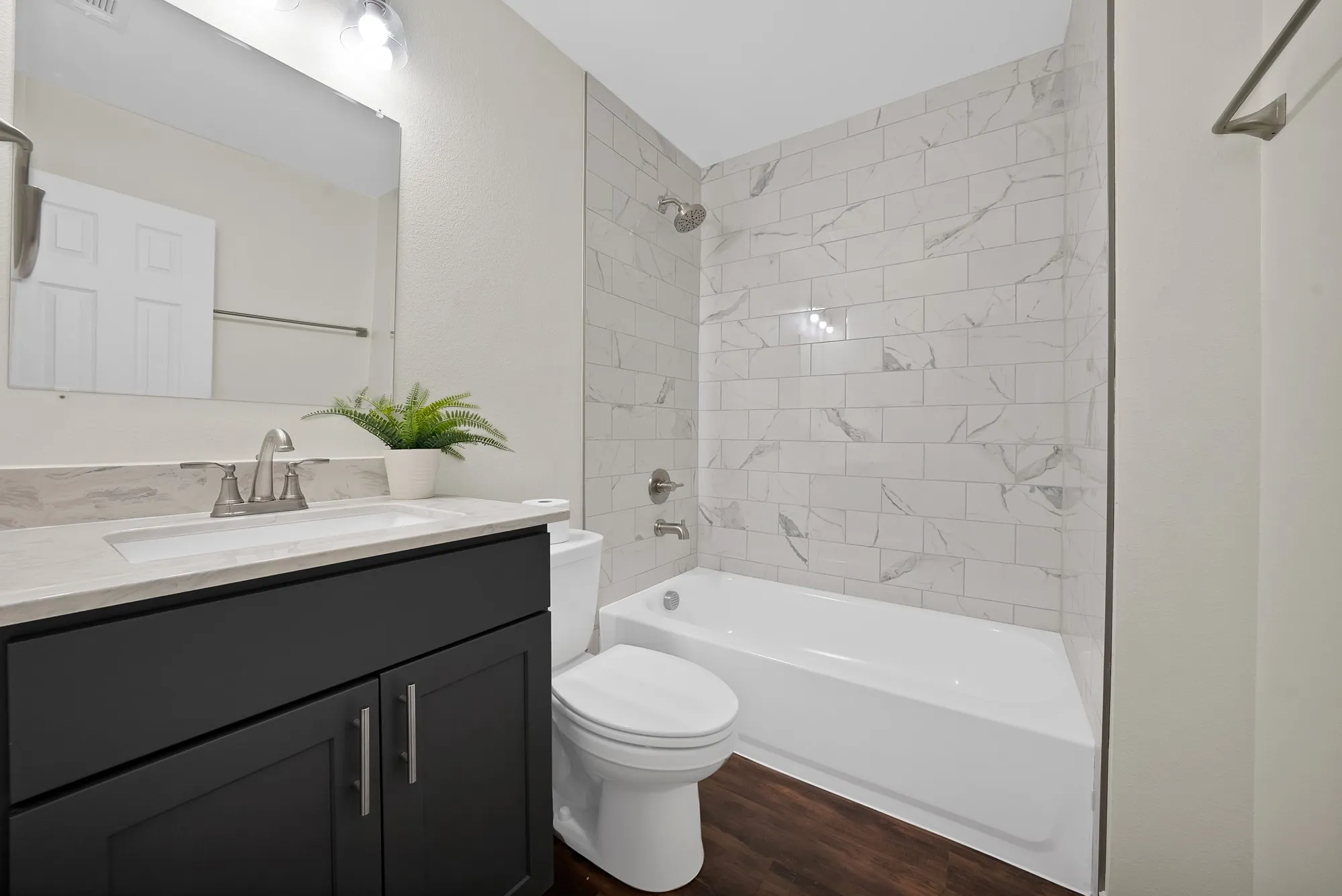 hall bathroom with new tub, cabinets and toilet