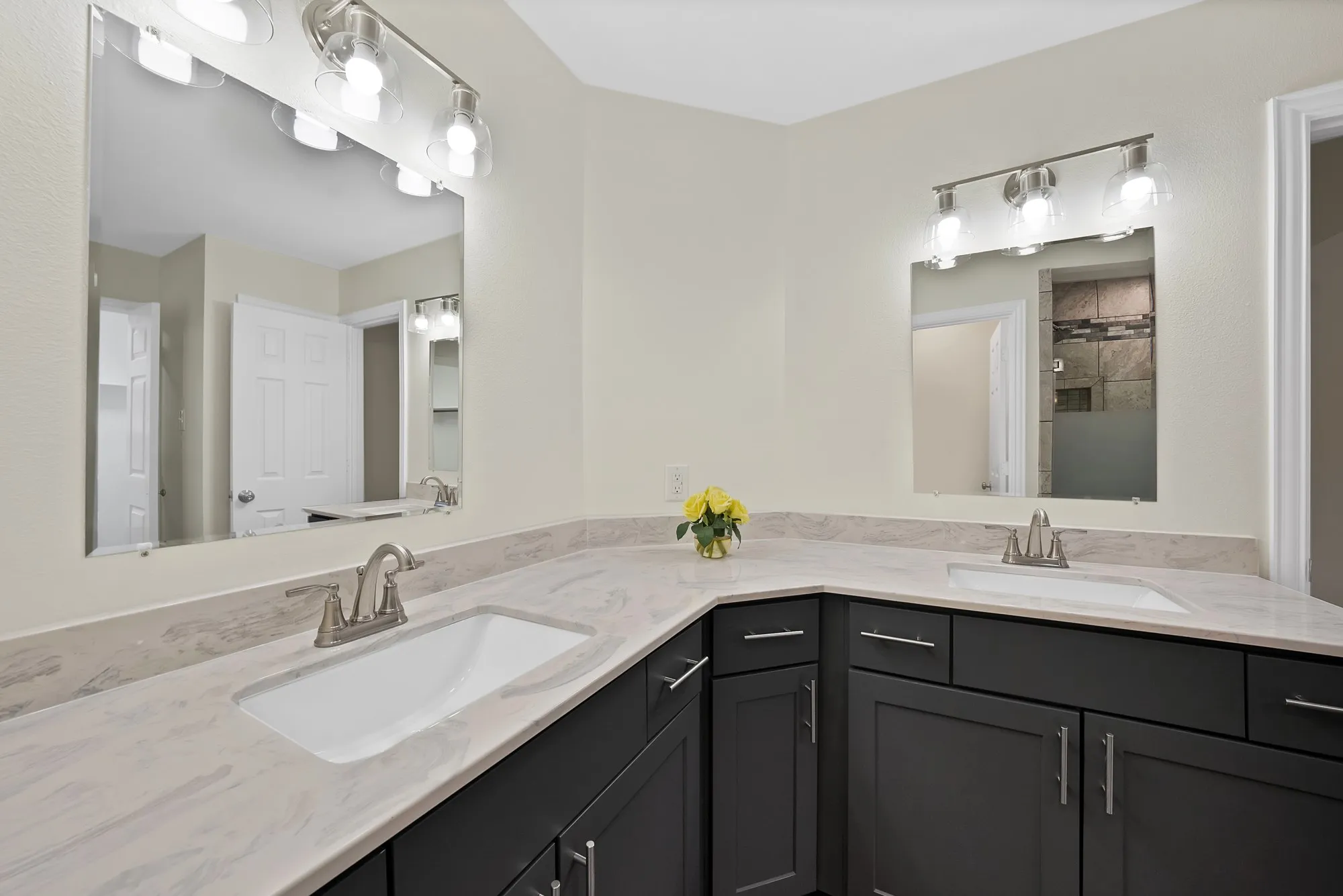 primary bathroom with new cabinets, sink, mirrors