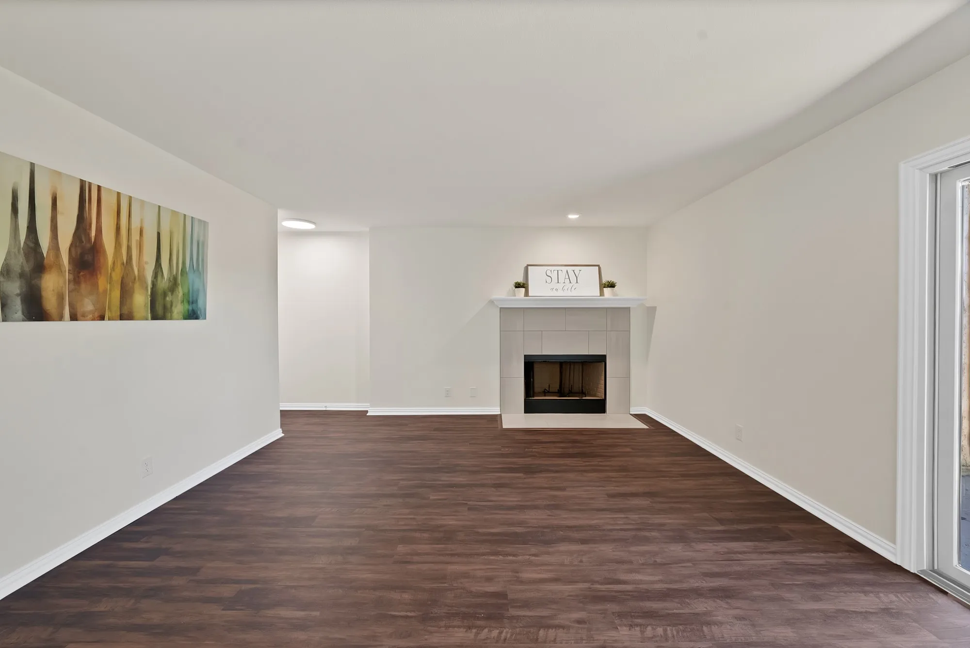 nice wood burning fireplace and wall space to hang photos or decorations.