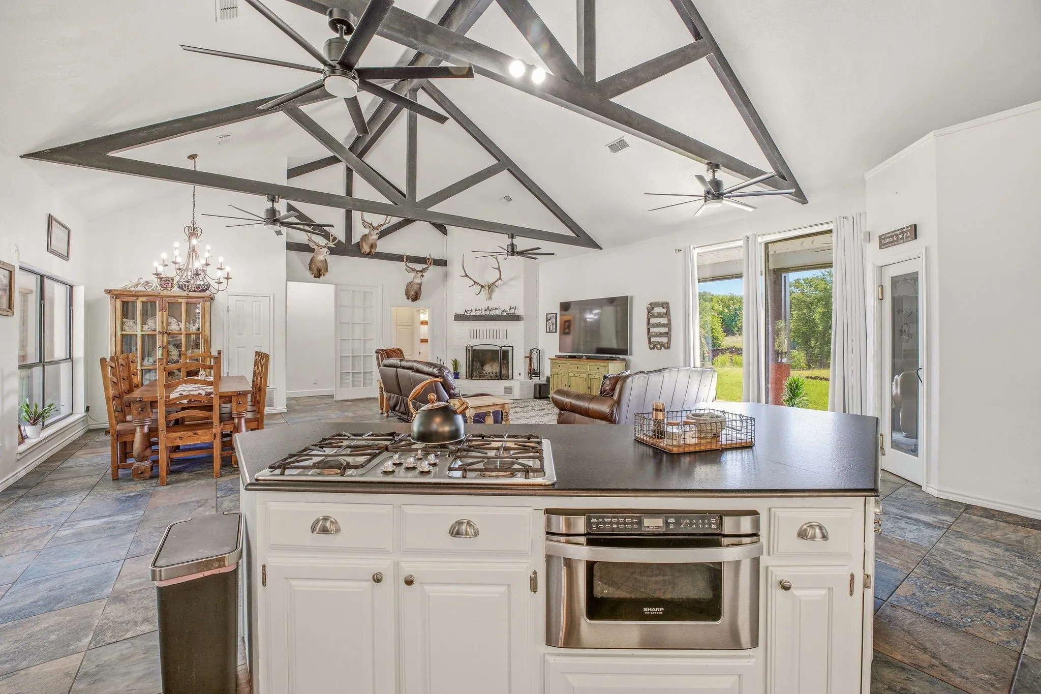 Kitchen island featuring a built-in gas range and microwave drawer
