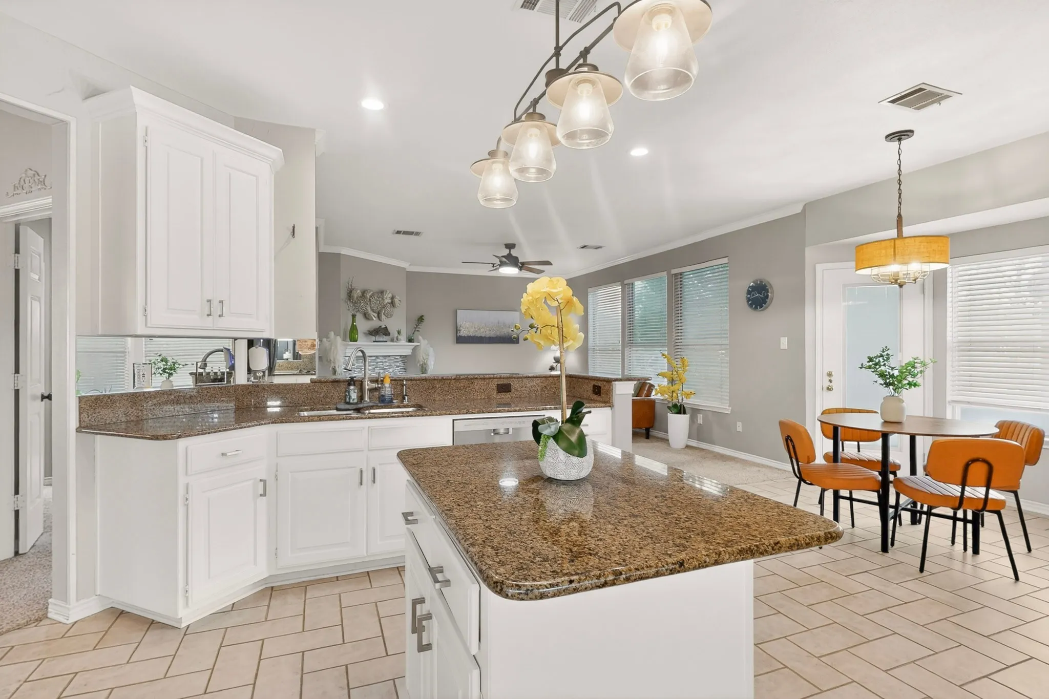 Kitchen featuring white cabinetry, granite countertops, a central island, tile flooring, and recessed lighting