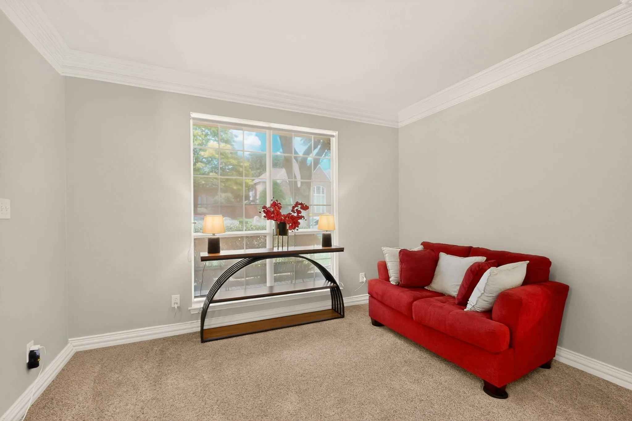 Neutral wall paint, crown molding, and baseboard trim enhance this versatile room
