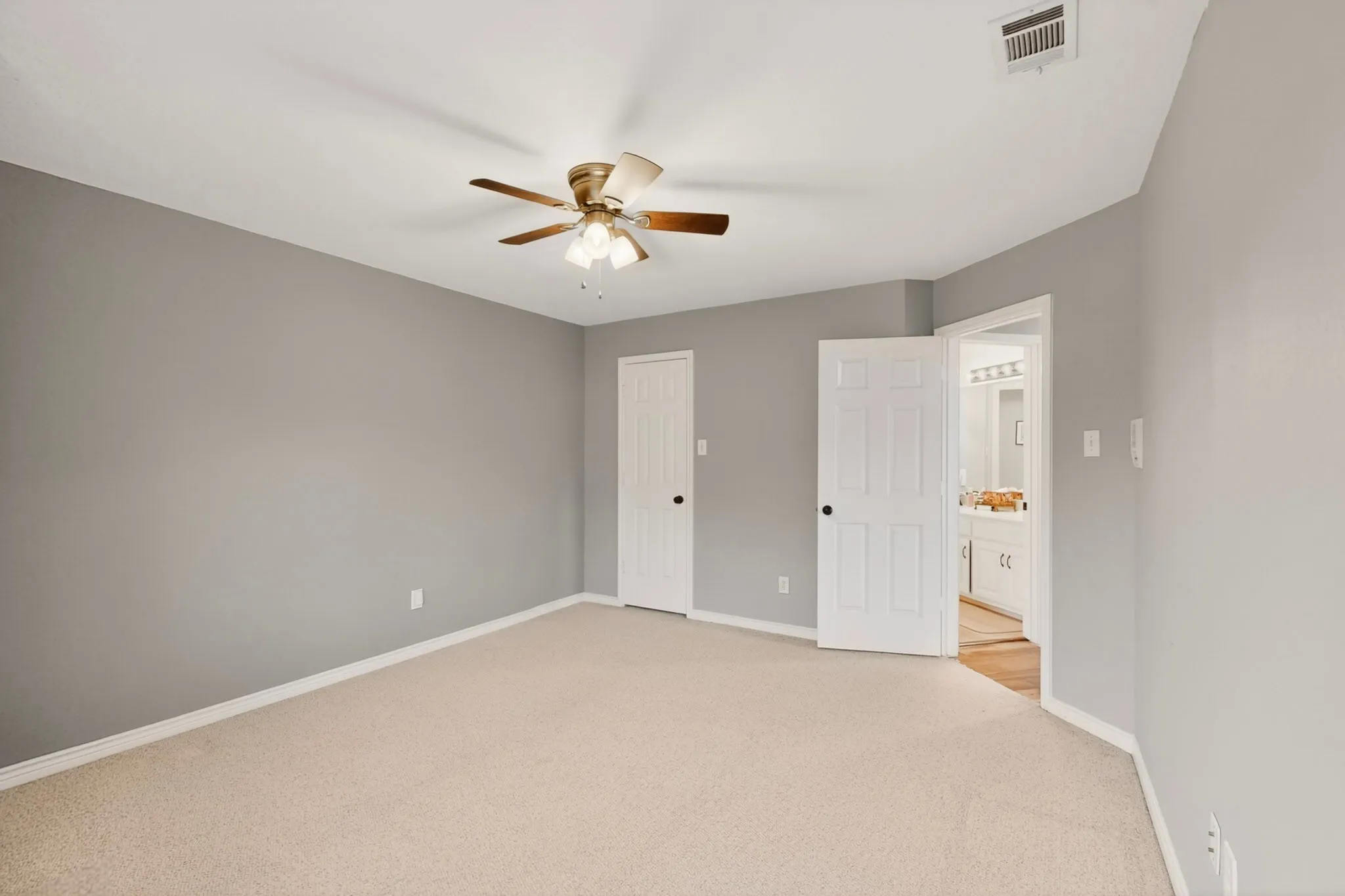 Carpeted room with light gray walls and white trim