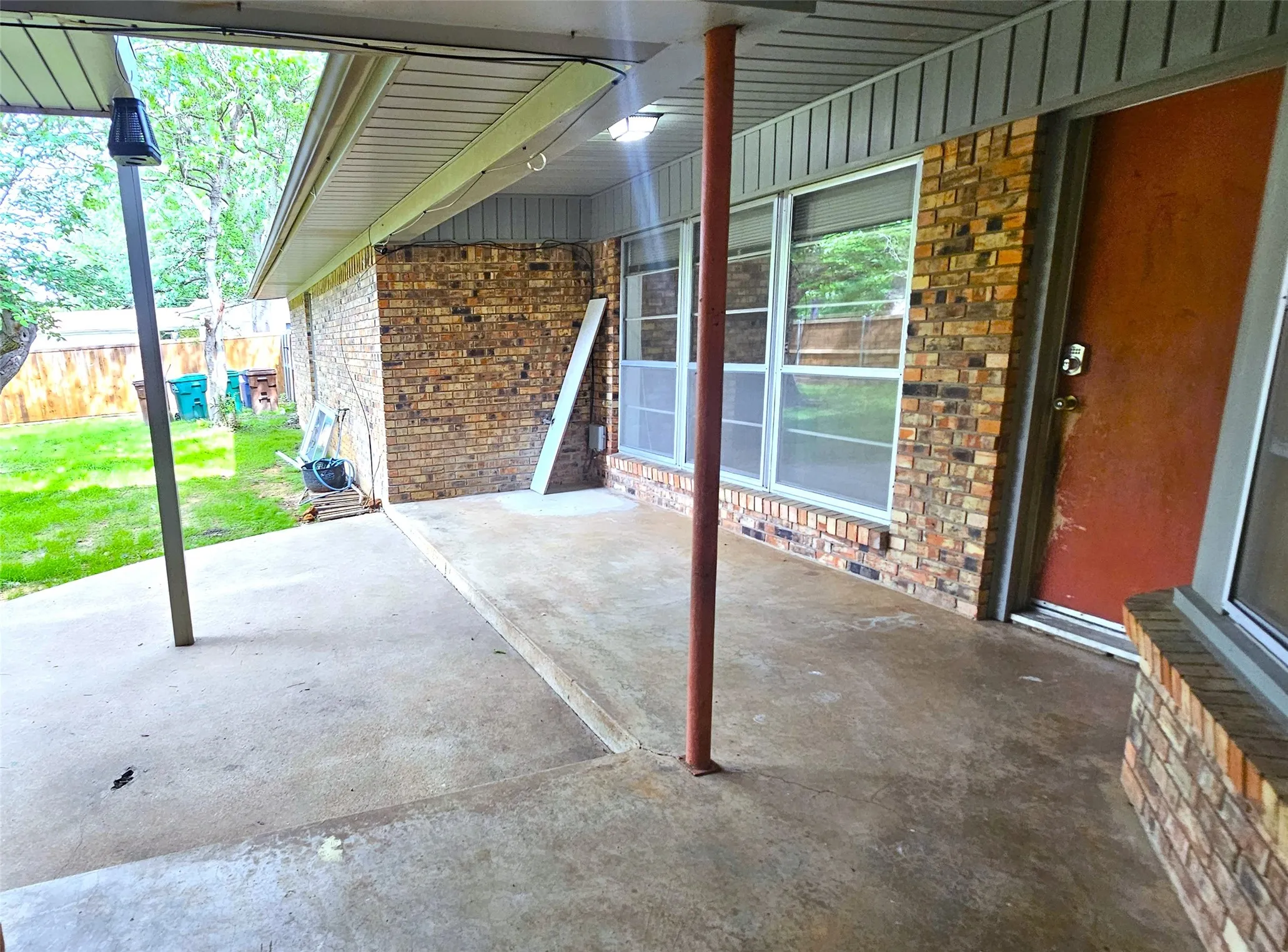 View of covered patio when you step out of Bedroom 4.