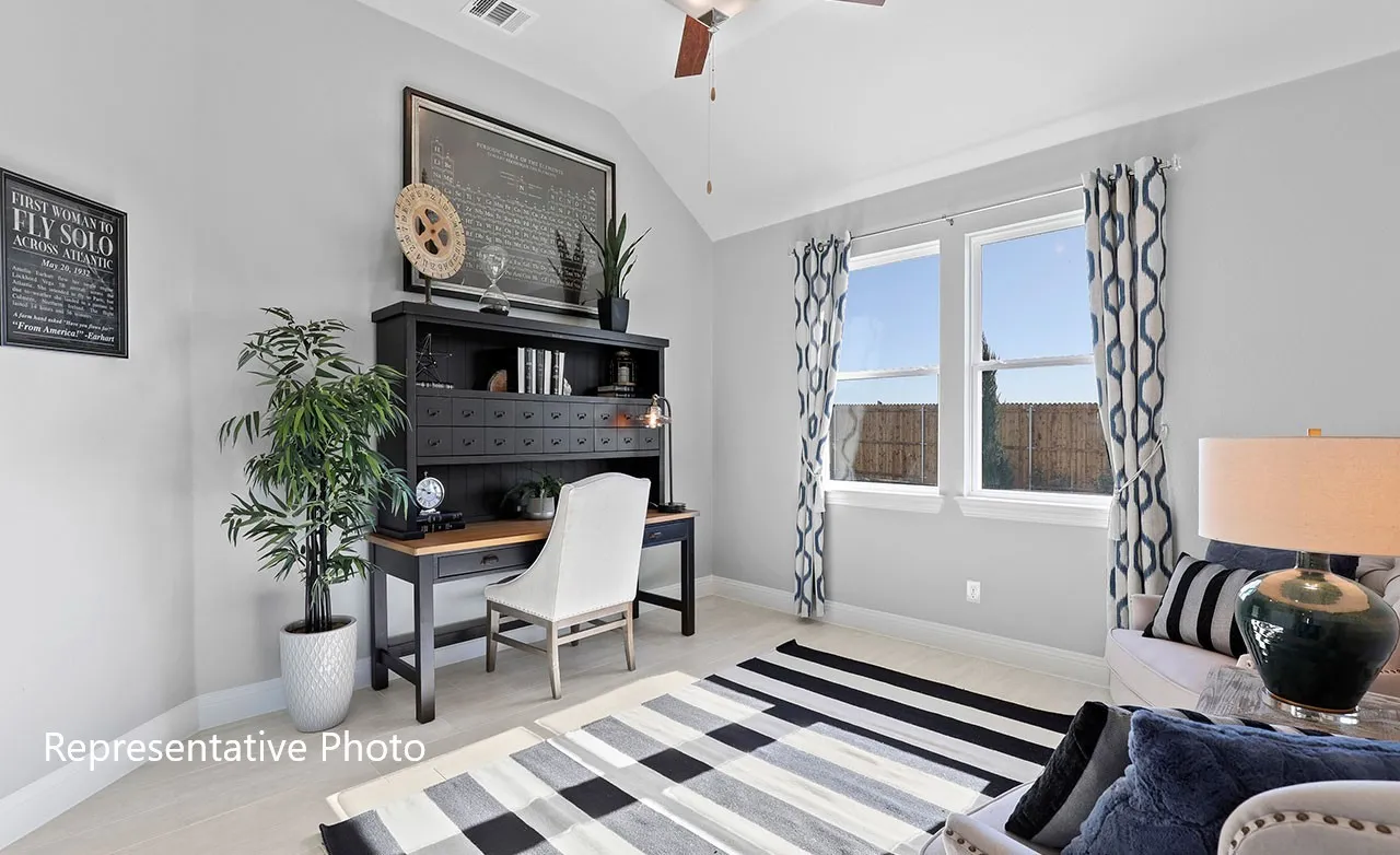Spacious room featuring vaulted ceilings, light-tone wood-finish flooring, and two large windows with white trim