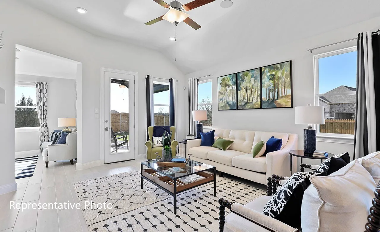 Vaulted ceiling living area featuring wood-finish flooring and recessed lighting