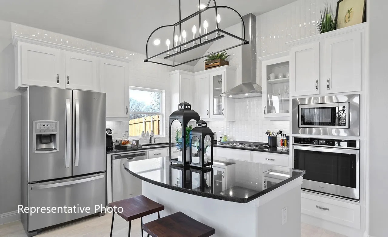 Modern kitchen featuring white cabinetry, stainless steel appliances, a center island with a dark countertop, and a white subway tile backsplash