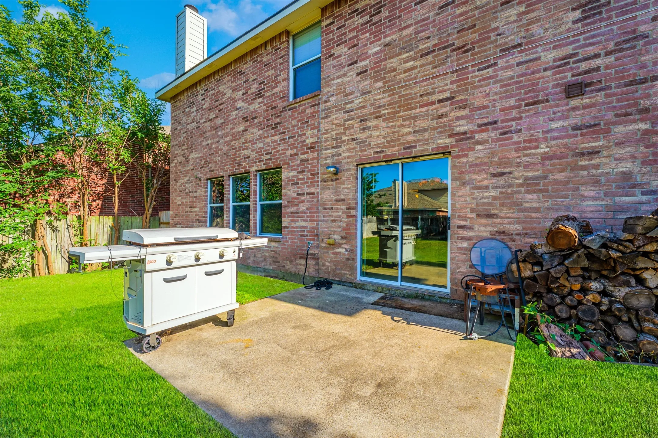Back patio and back side of brick house