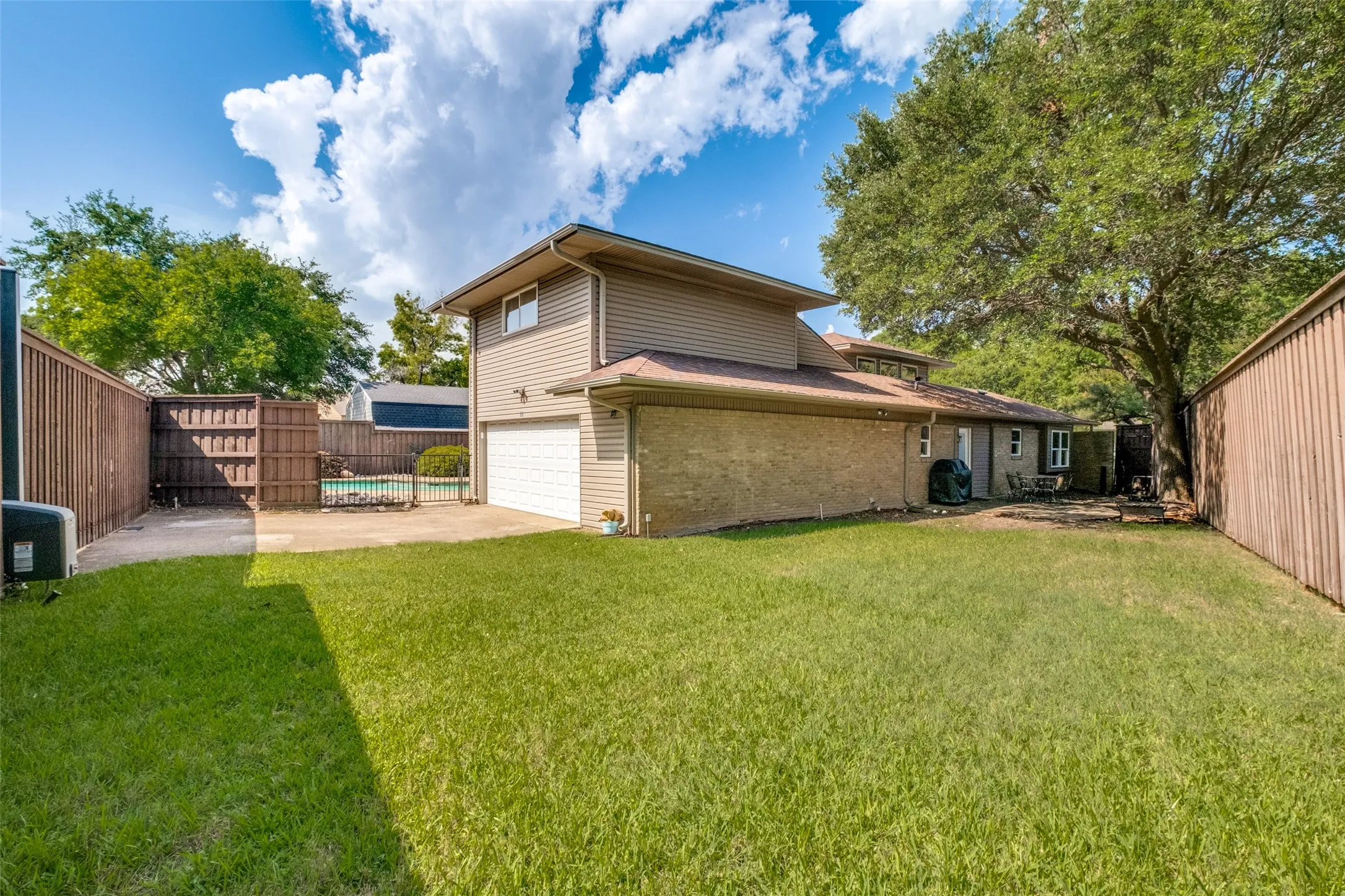 Huge grassy yard with patio on the north side of the home
