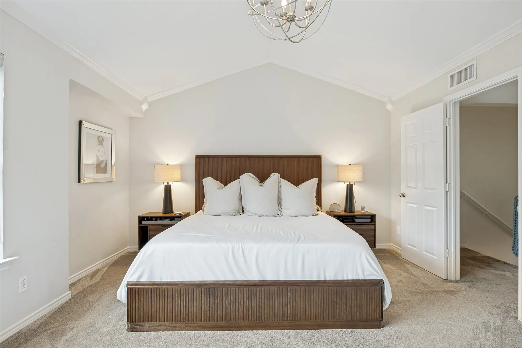 King sized primary bedroom with vaulted ceilings