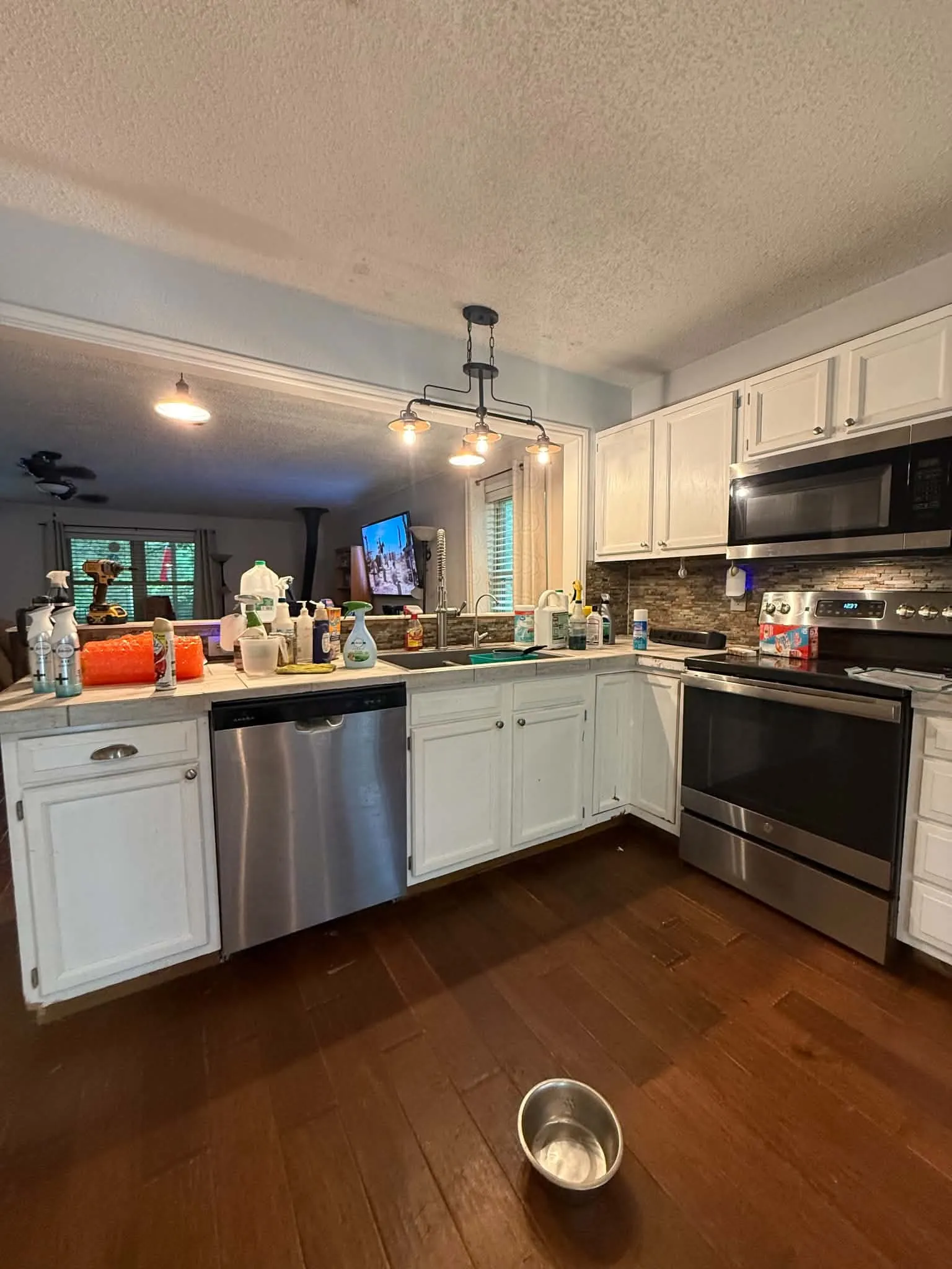 Kitchen featuring white cabinetry, stainless steel dishwasher, stainless steel range, and stainless steel microwave