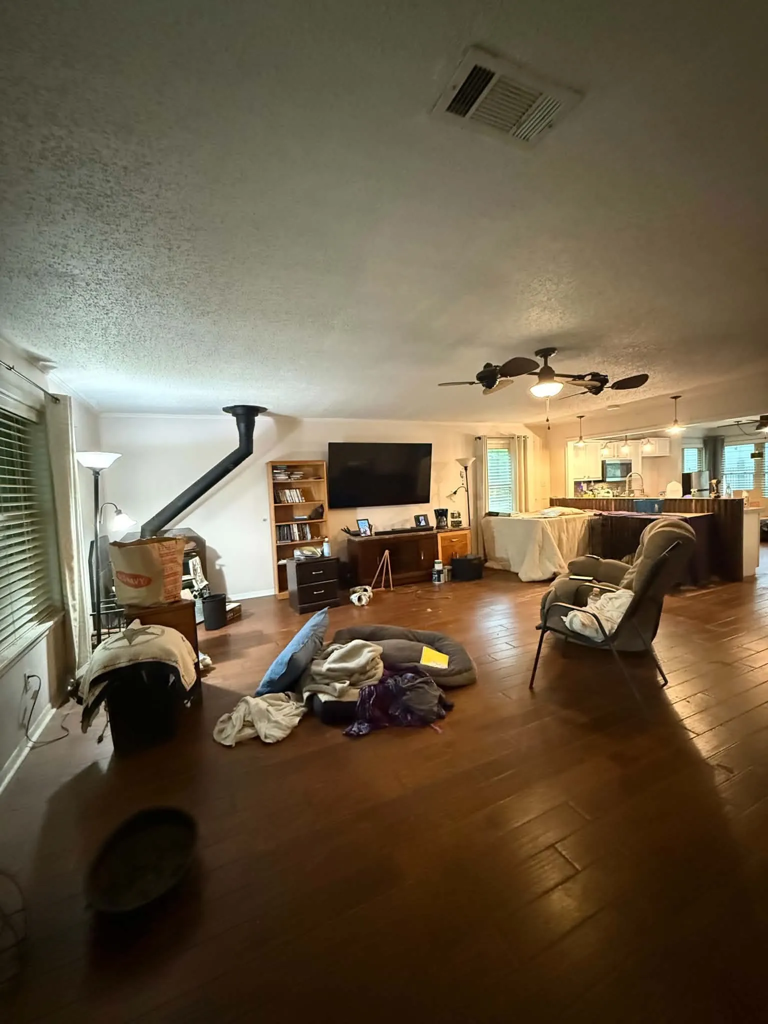 Open-concept living space featuring wood-finish flooring, a contemporary ceiling fan, and recessed lighting