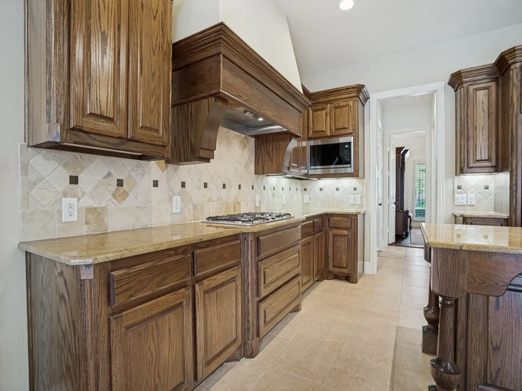     Abundant countertop space paired with a spacious walk-in pantry for exceptional storage and functionality.