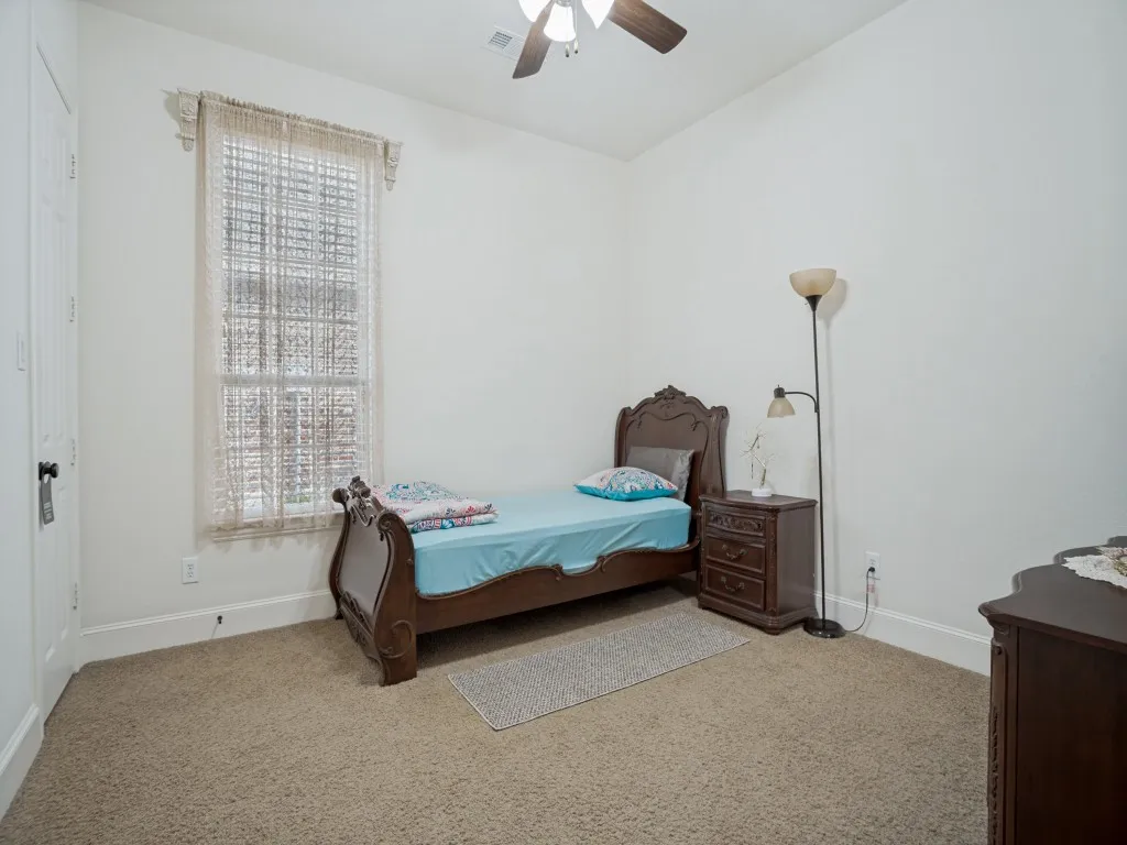     Private secondary bedroom downstairs with ensuite bath, one of three bedrooms conveniently located on the main level.
