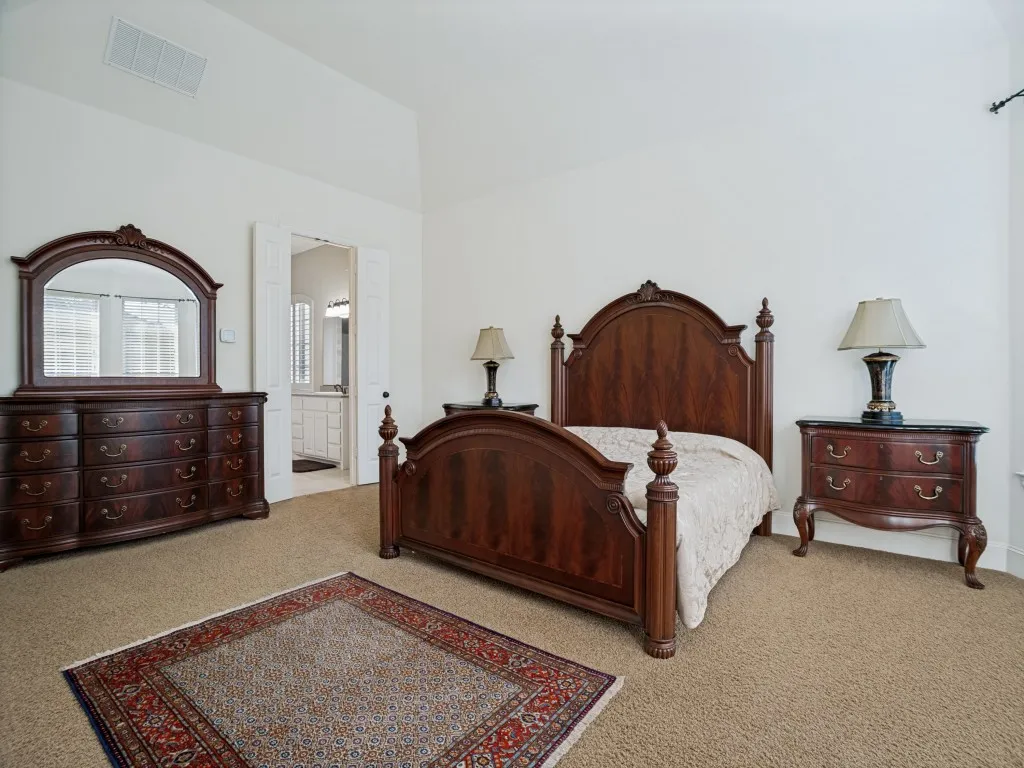     Spacious primary retreat with room for a sitting area and peaceful views of the backyard.