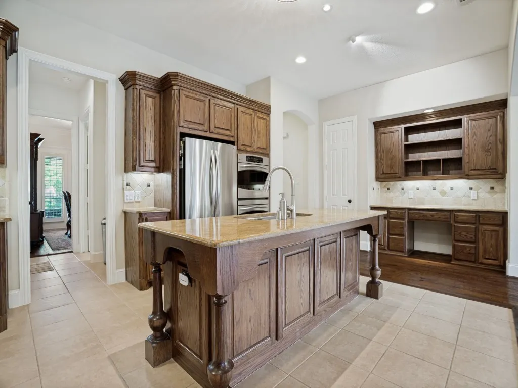     Open concept kitchen centered around a large island, perfect for gathering and entertaining.