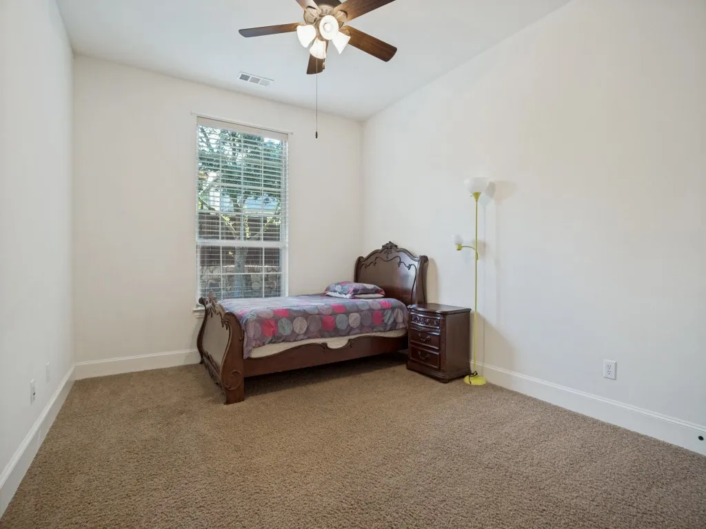     Private secondary bedroom downstairs, one of three bedrooms conveniently located on the main level.