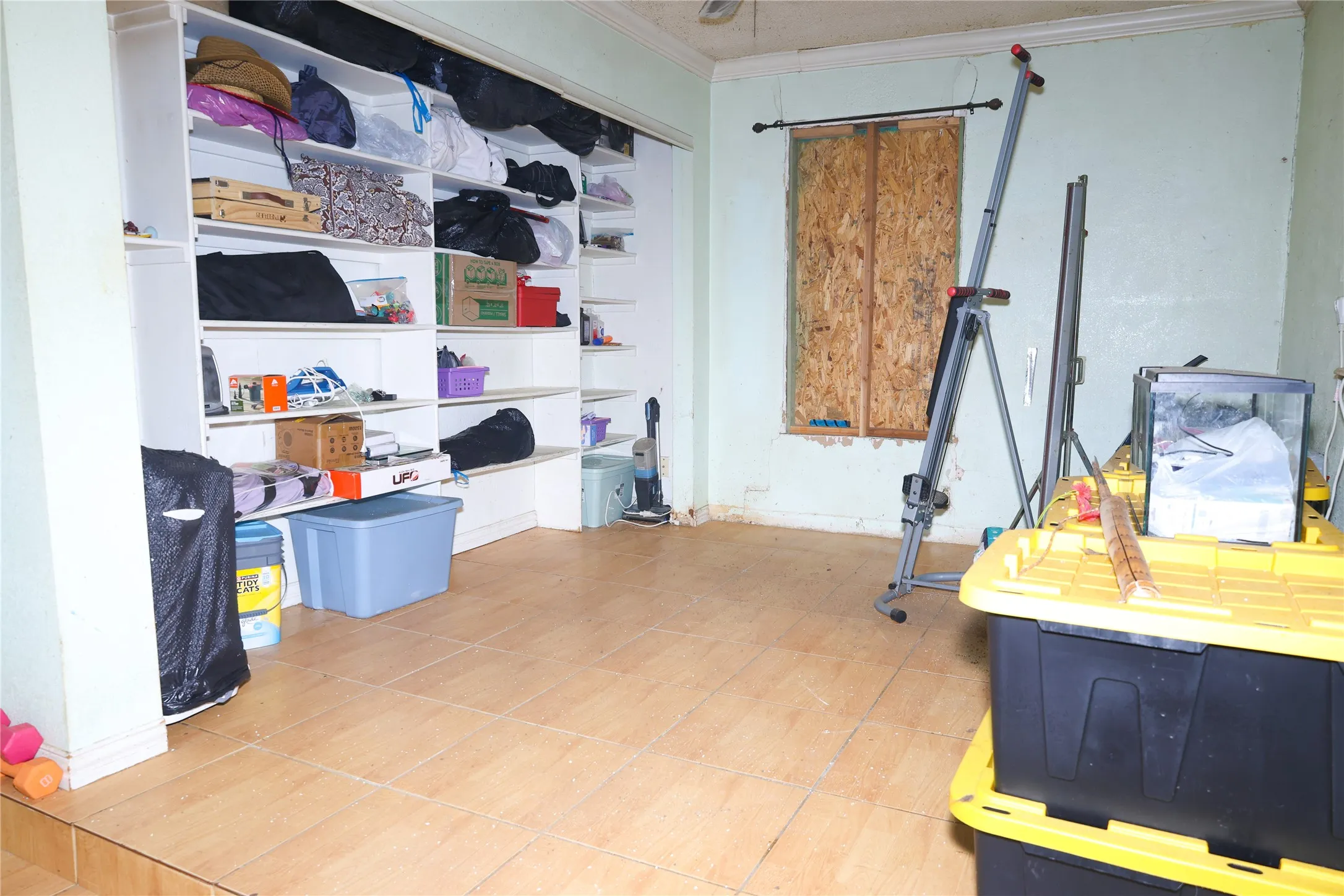 Built-in shelving with multiple storage compartments and tile flooring