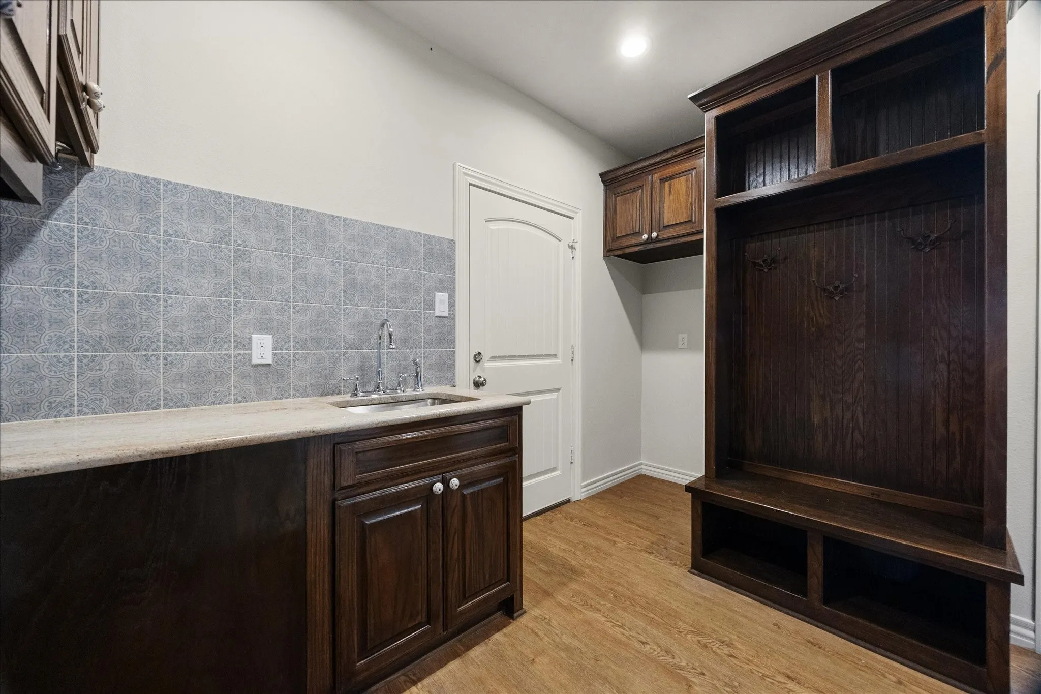 Perfectly positioned mud room with drop off area is located near garage entry