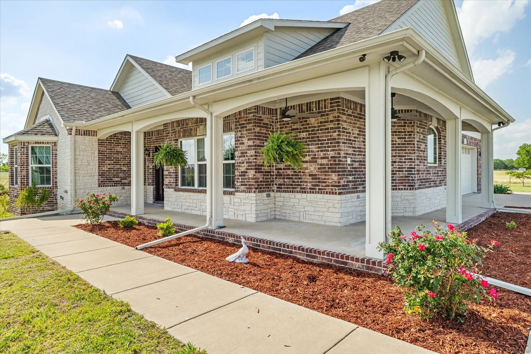 Welcoming covered porch overlooks property