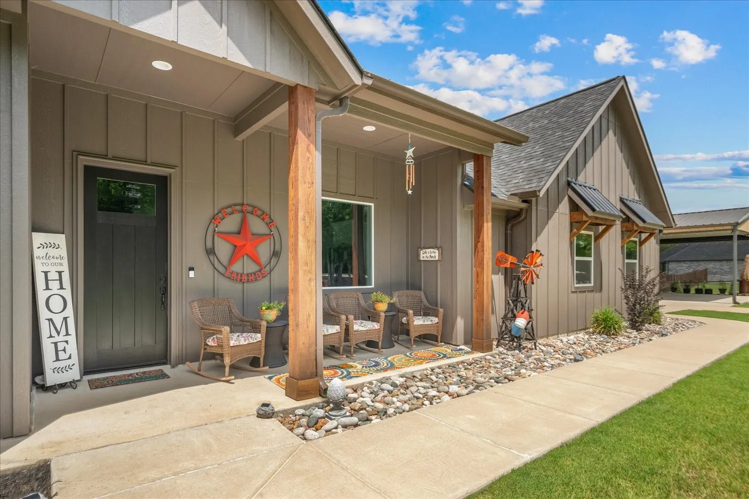 Covered front porch featuring wood support pillars