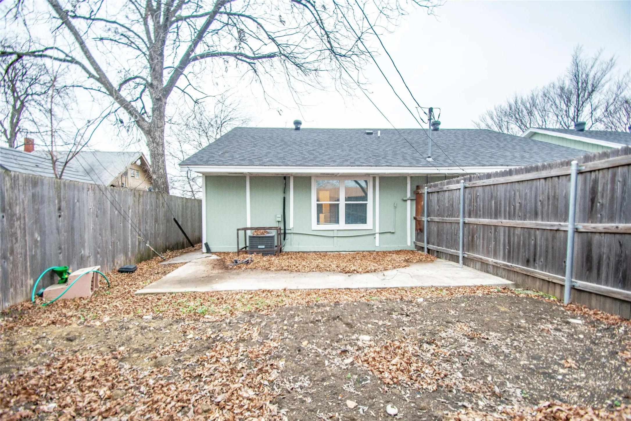 Back of house with a patio area and central air condition unit